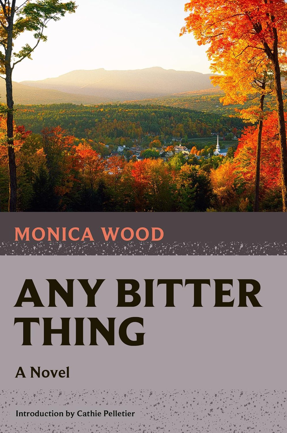 Book cover of 'Any Bitter Thing' by Monica Wood featuring a scenic view of a small town surrounded by autumn trees with colorful fall foliage and mountains in the background.