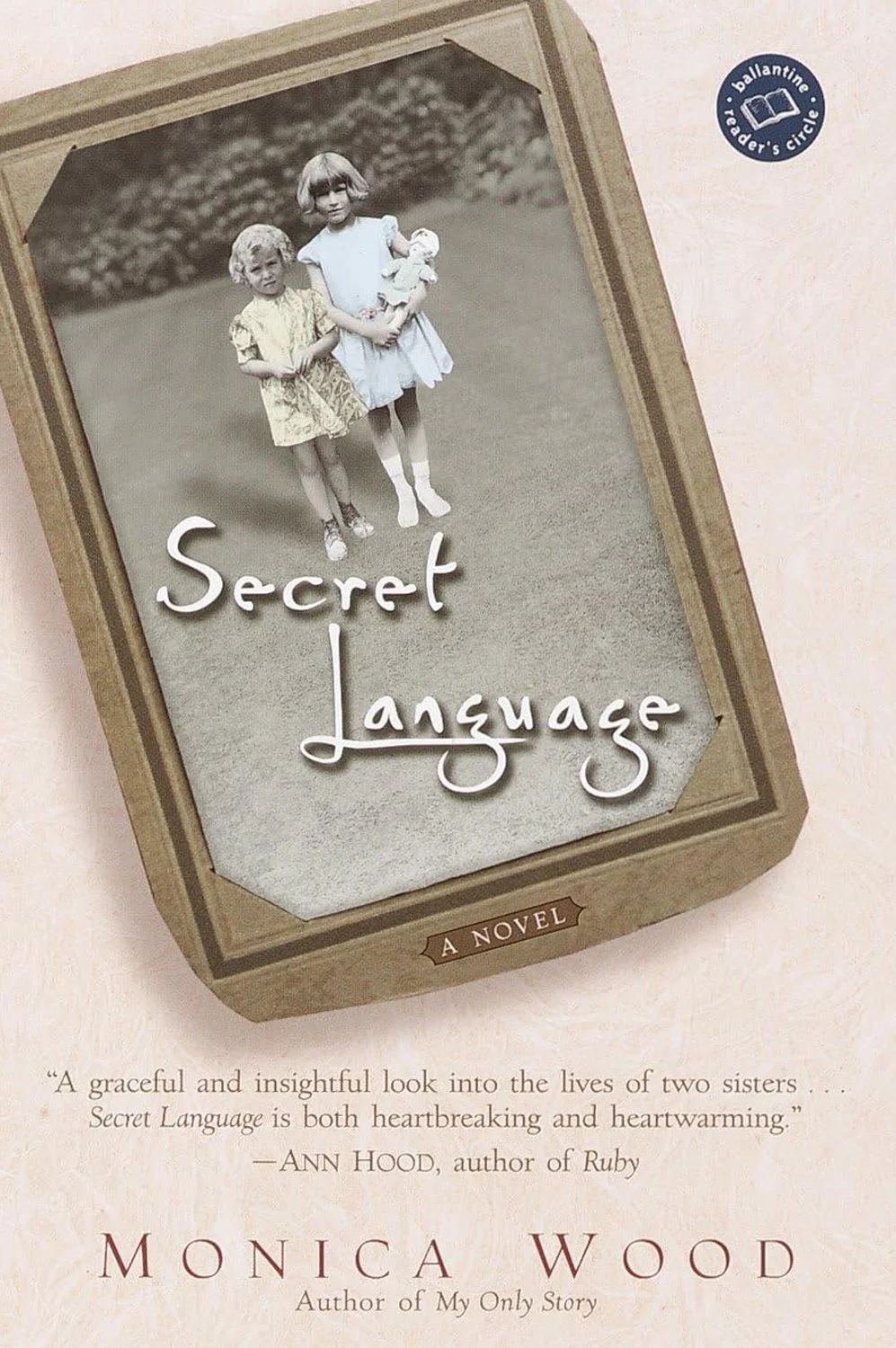 Book cover of "Secret Language" by Monica Wood, featuring a black-and-white photograph of two young girls standing outdoors, one holding a doll.