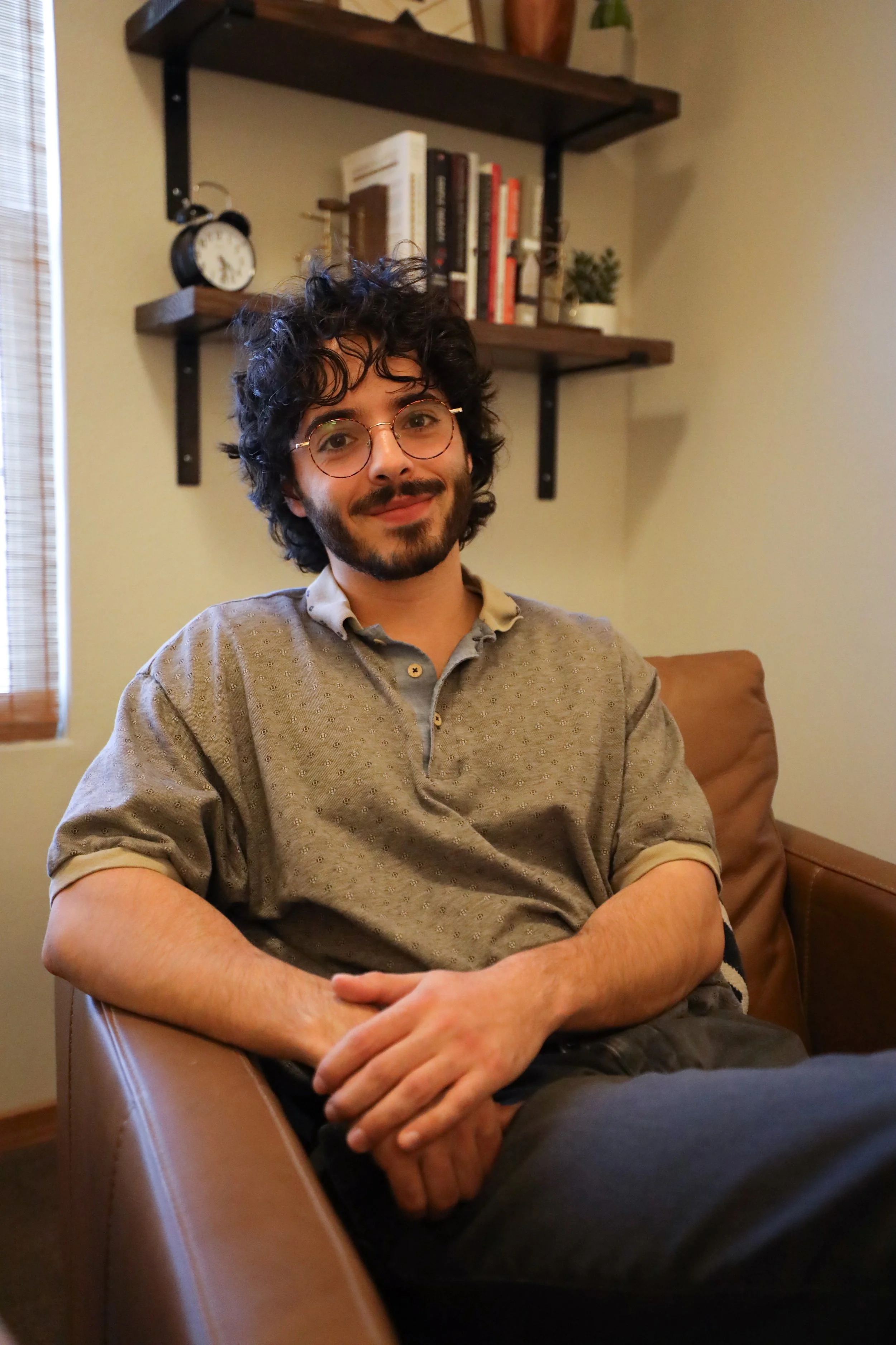 Joshua Korac sitting in a therapy office.