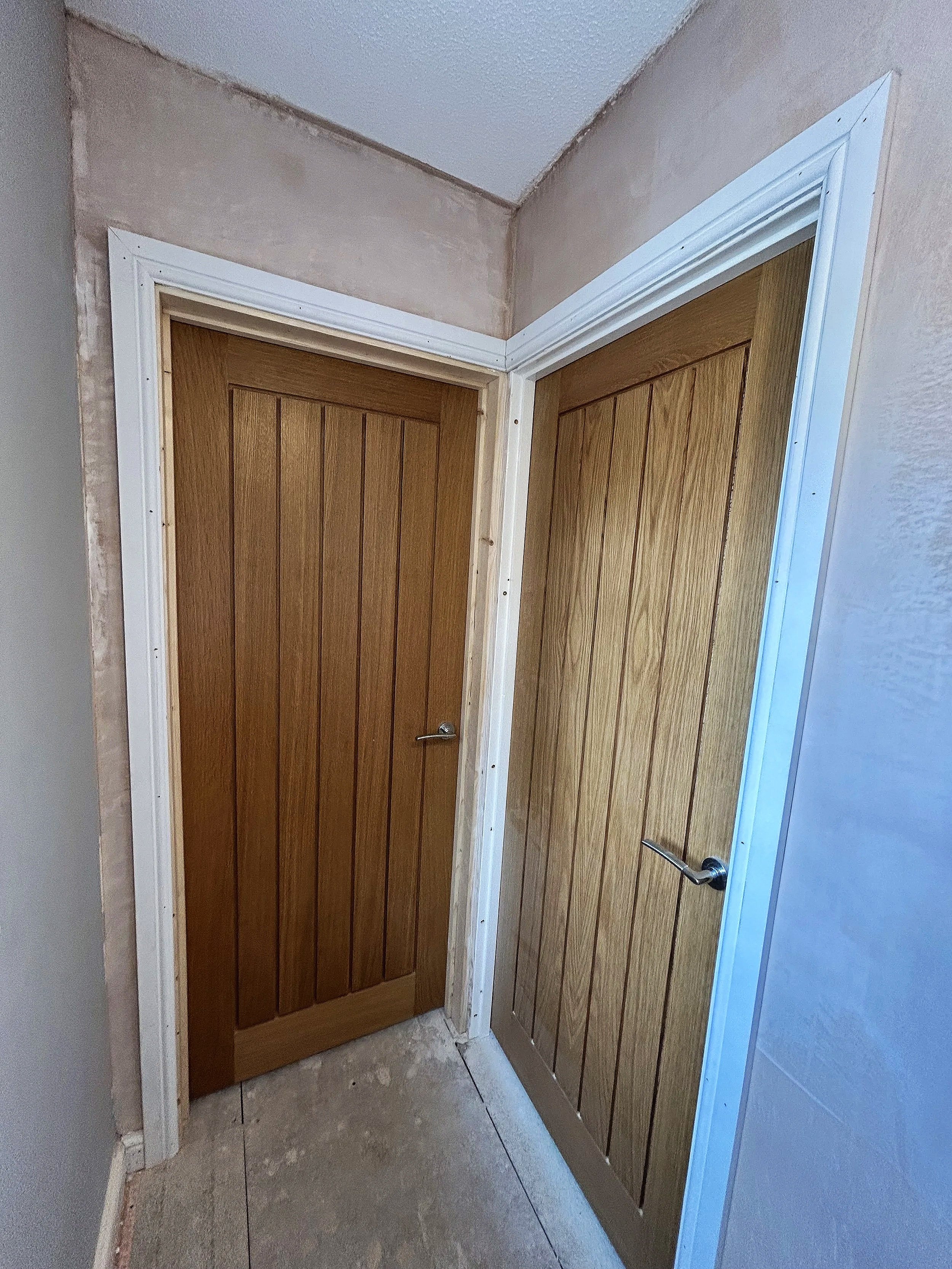cottage oak doors in a white frame, upstairs doors installed with architrave and skirting