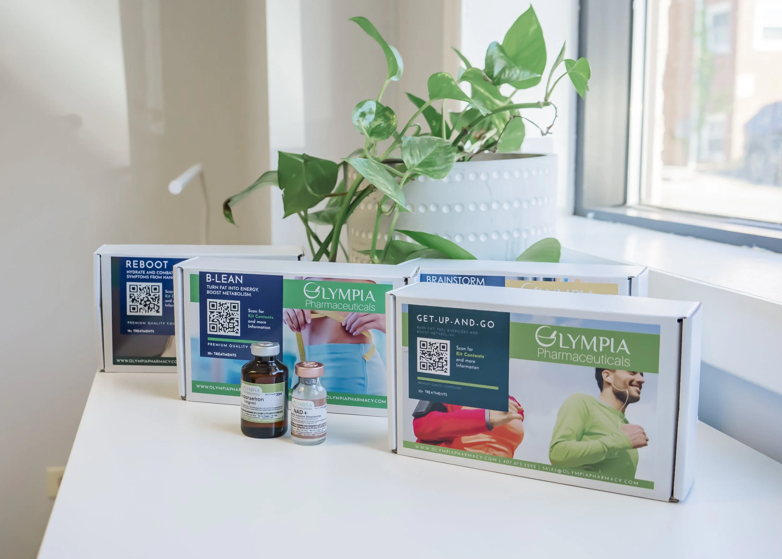 Olympia Pharmaceuticals IV therapy kits displayed on a treatment counter at Carla Thomas Med Spa, featuring vitamin blends like NAD+, B-Lean, and Get-Up-and-Go for hydration, energy, and wellness support.