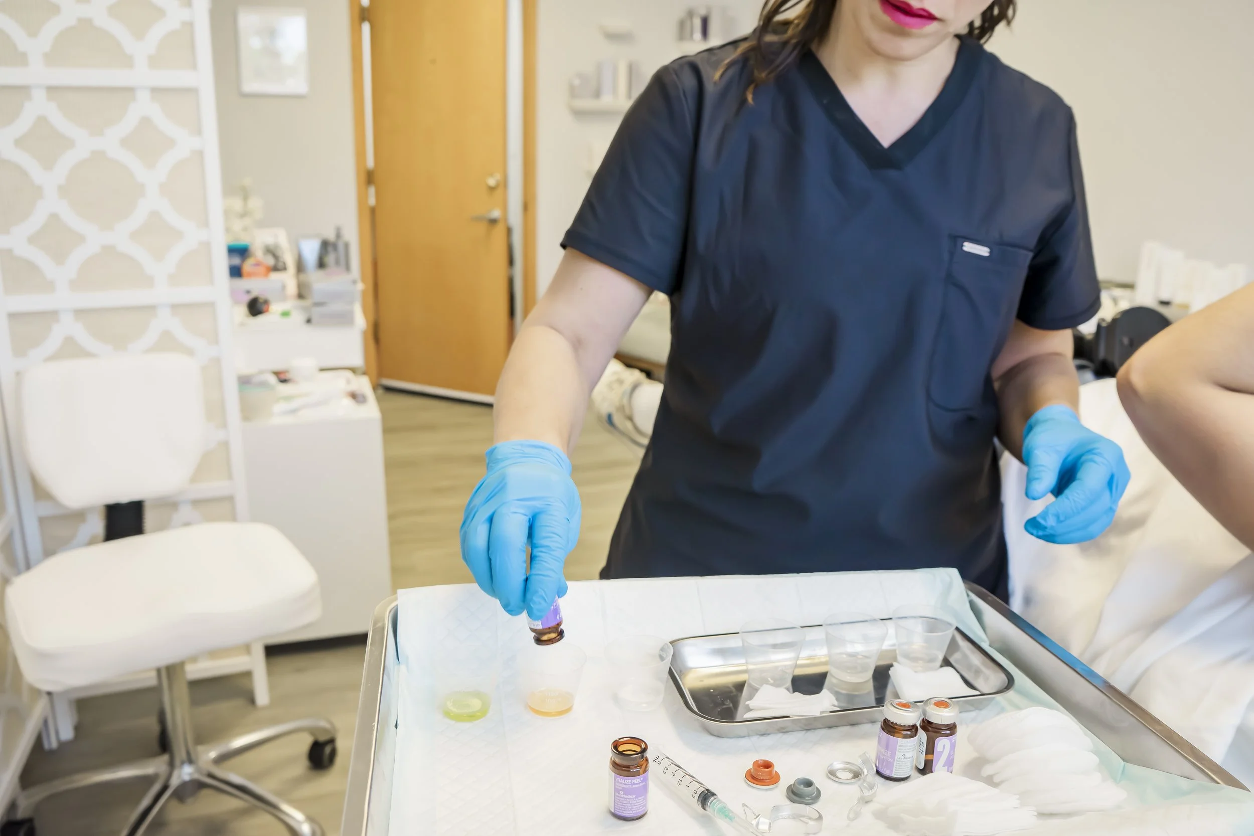 Aesthetic provider at Carla Thomas Med Spa preparing a customized chemical peel treatment using medical-grade serums