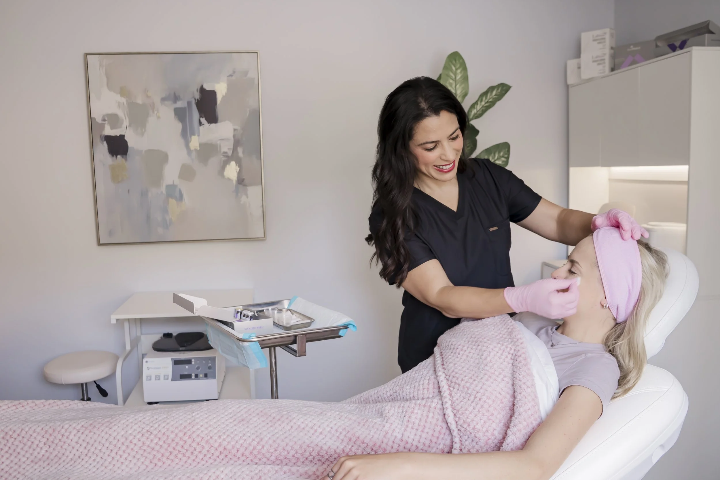 Nurse Practitioner Carla preparing a client’s skin for a chemical peel at Carla Thomas Med Spa in La Grange, IL.