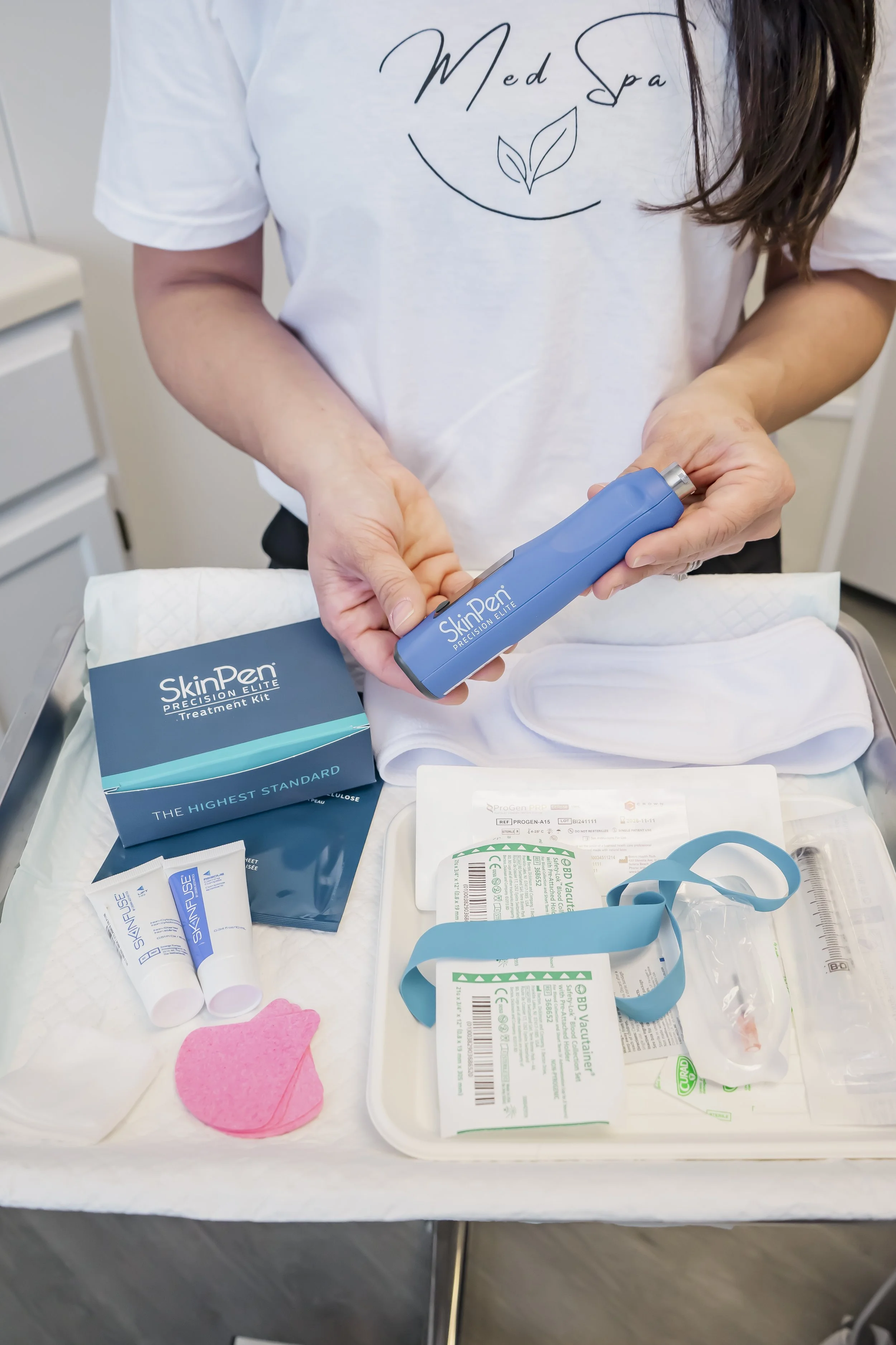 Medical professional holding a SkinPen microneedling device with a full treatment kit at Carla Thomas Med Spa