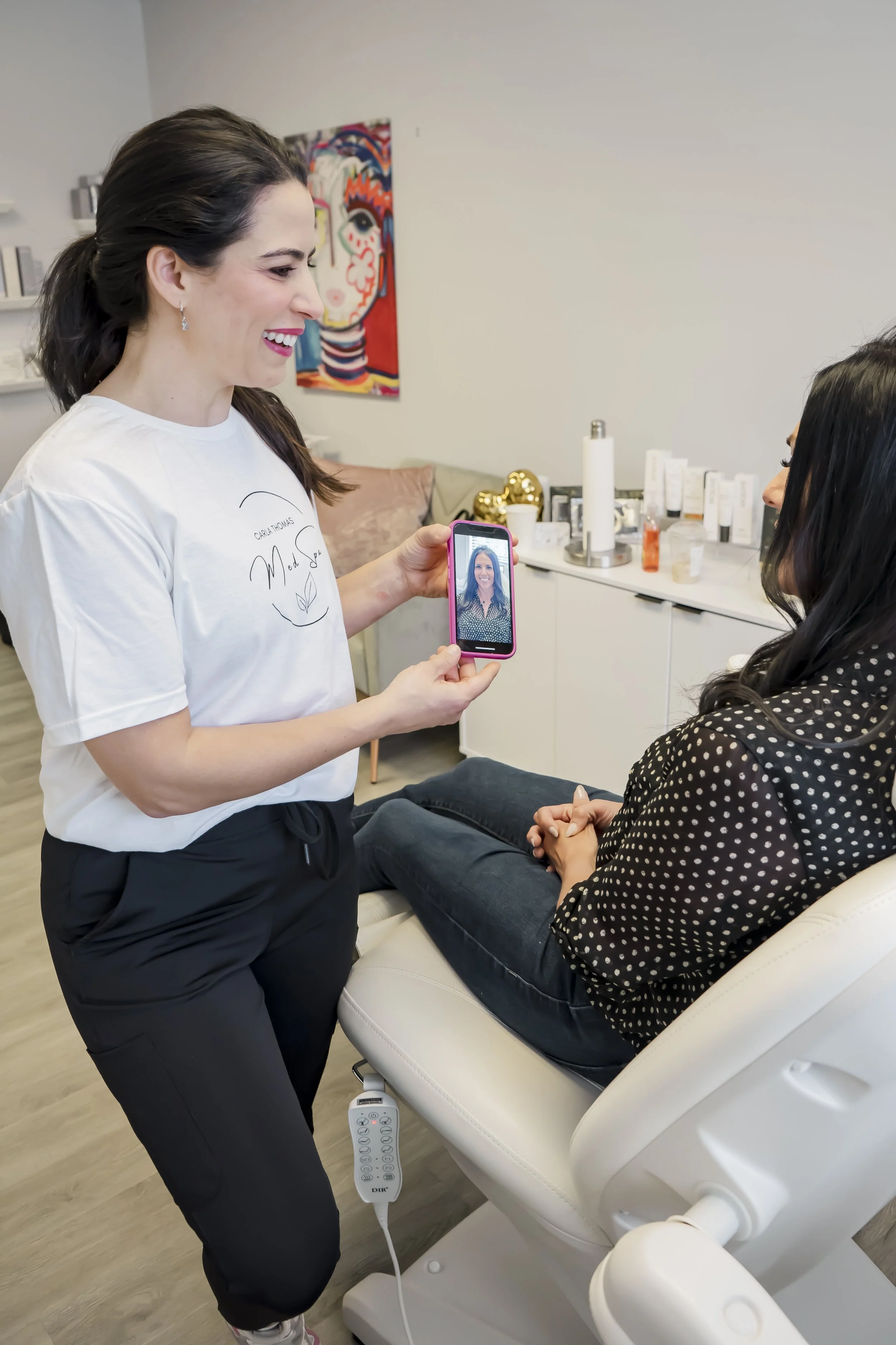 Nurse Practitioner Carla showing a before photo to her client during a personalized consultation at Carla Thomas Med Spa in La Grange, IL.