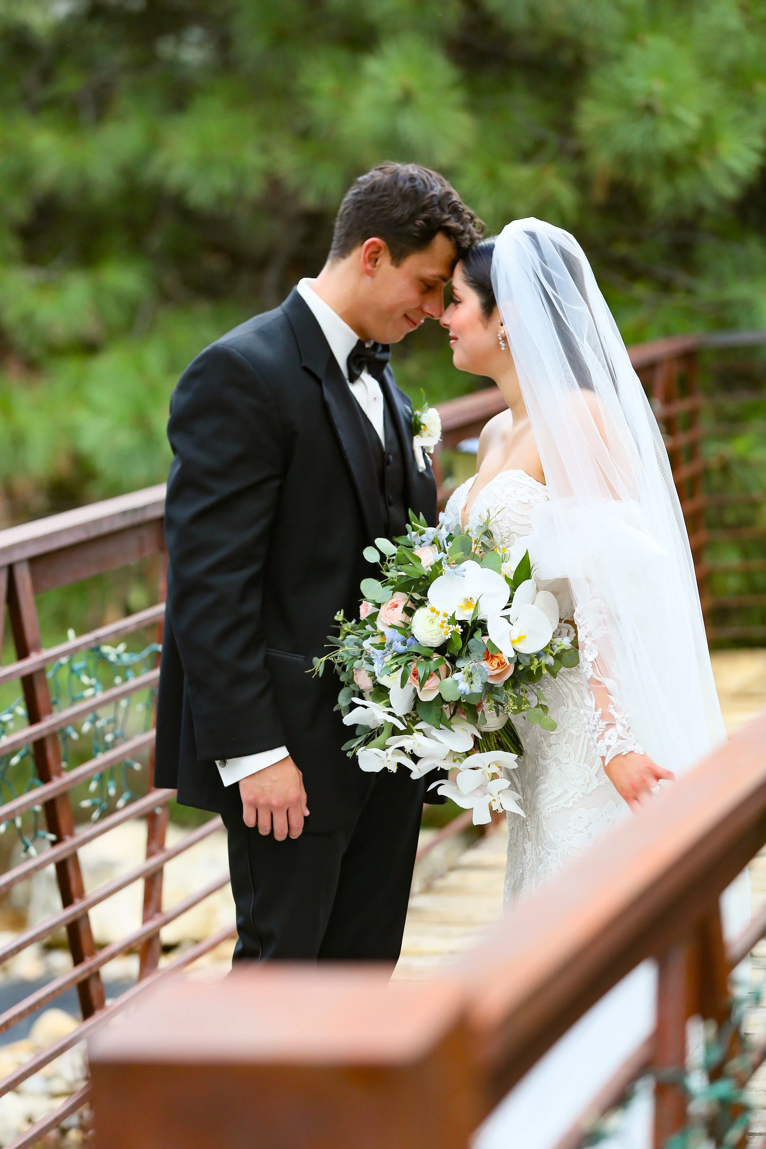 Bride and groom sharing a quiet moment on a bridge during their Nature Pointe in Tijeras New Mexico wedding