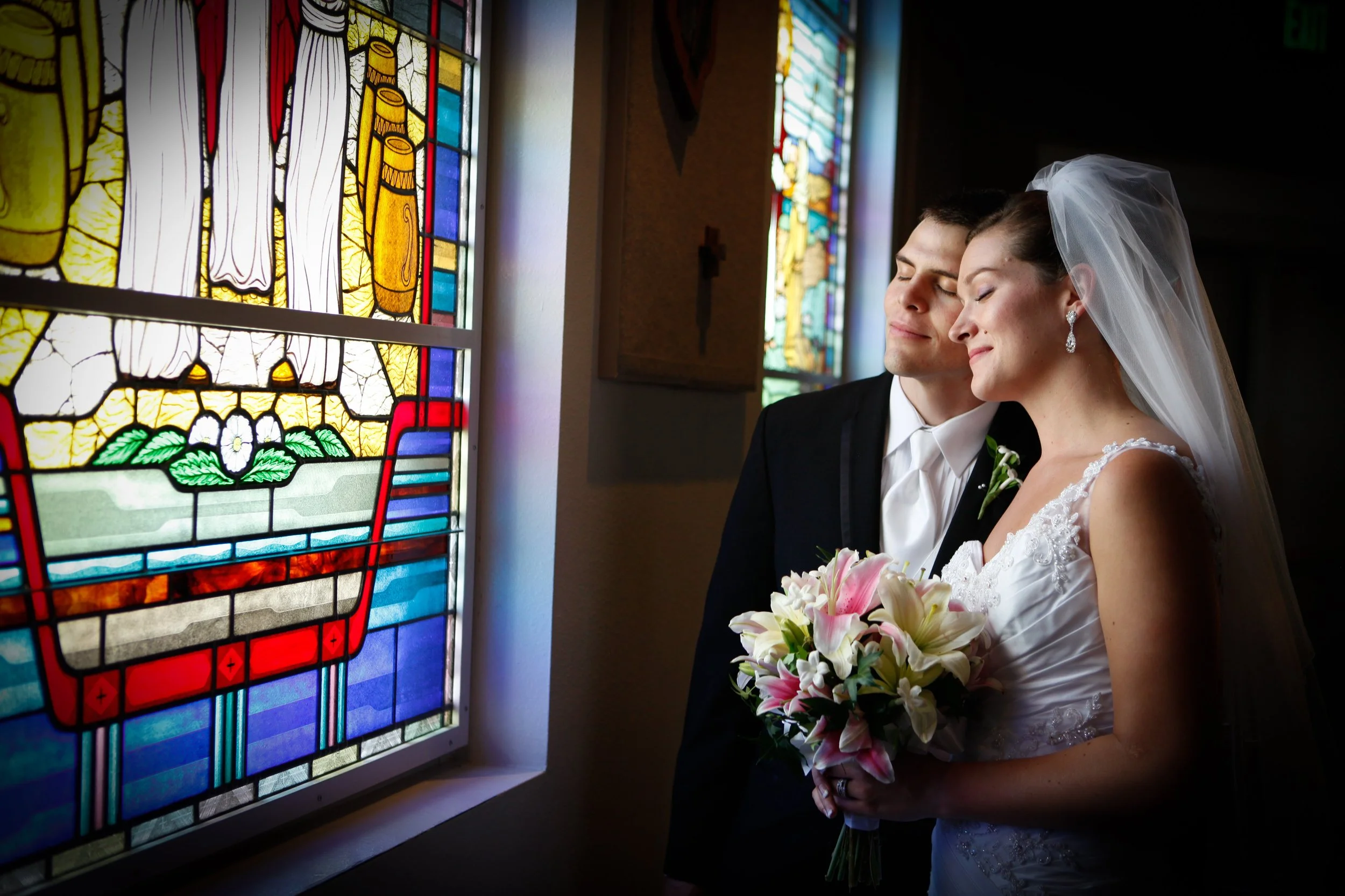 Married couple look at stain glass at annunciation parish.JPG
