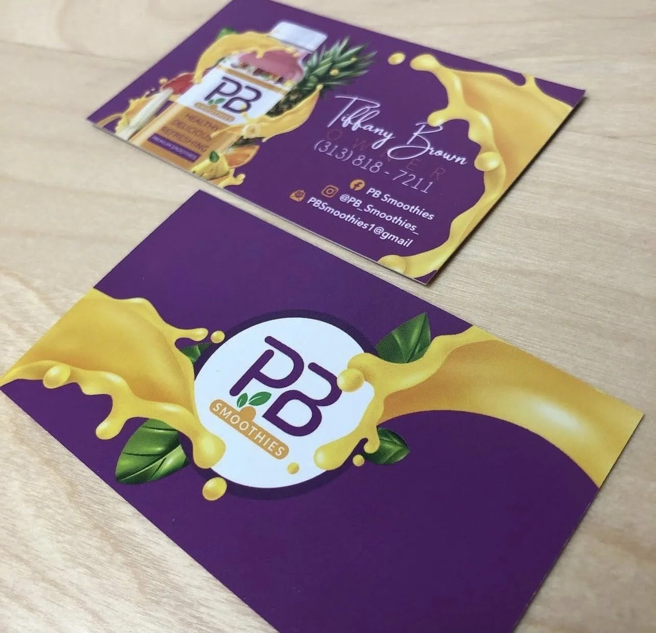 Business card for PB Smoothies with a purple and yellow design, including a pineapple and green leaves, and contact information for Tiffany Brown.