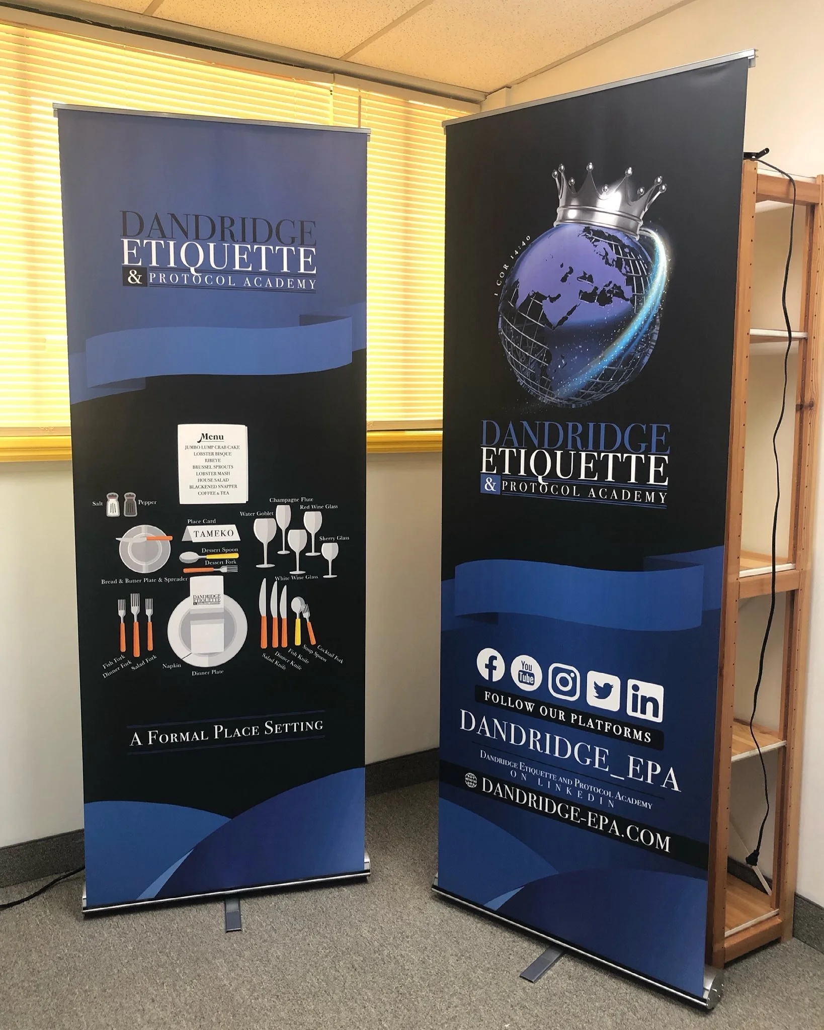Two vertical banners promoting Dandridge Etiquette & Protocol Academy; the left banner has a diagram of table setting and a menu, the right banner features a globe with a crown and social media icons.
