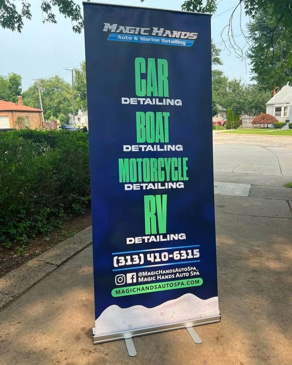 A vertical blue banner advertising Magic Hands Auto & Marine Detailing services, including car, boat, motorcycle, and RV detailing. Contains contact information and social media handles.