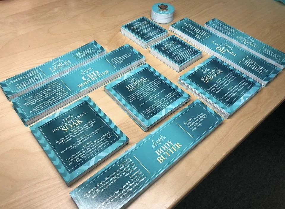 Assorted skincare product packages with blue and teal labels arranged on a wooden table.