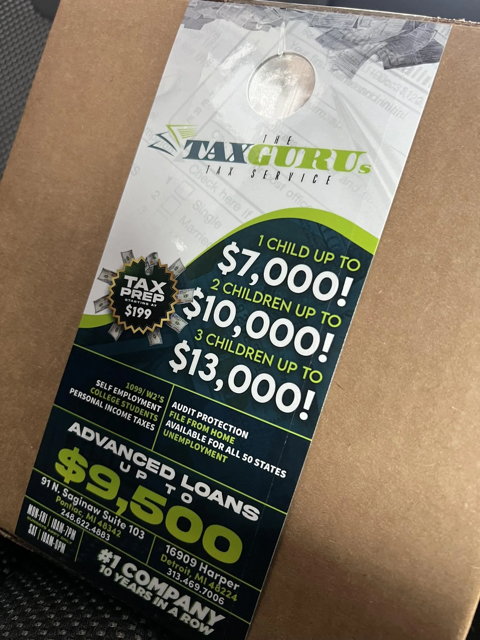 A flyer for The Tax Guru tax service promoting child tax credit amounts, tax prep prices, and loan options, with contact information for locations in Pontiac, MI, and Detroit, MI.