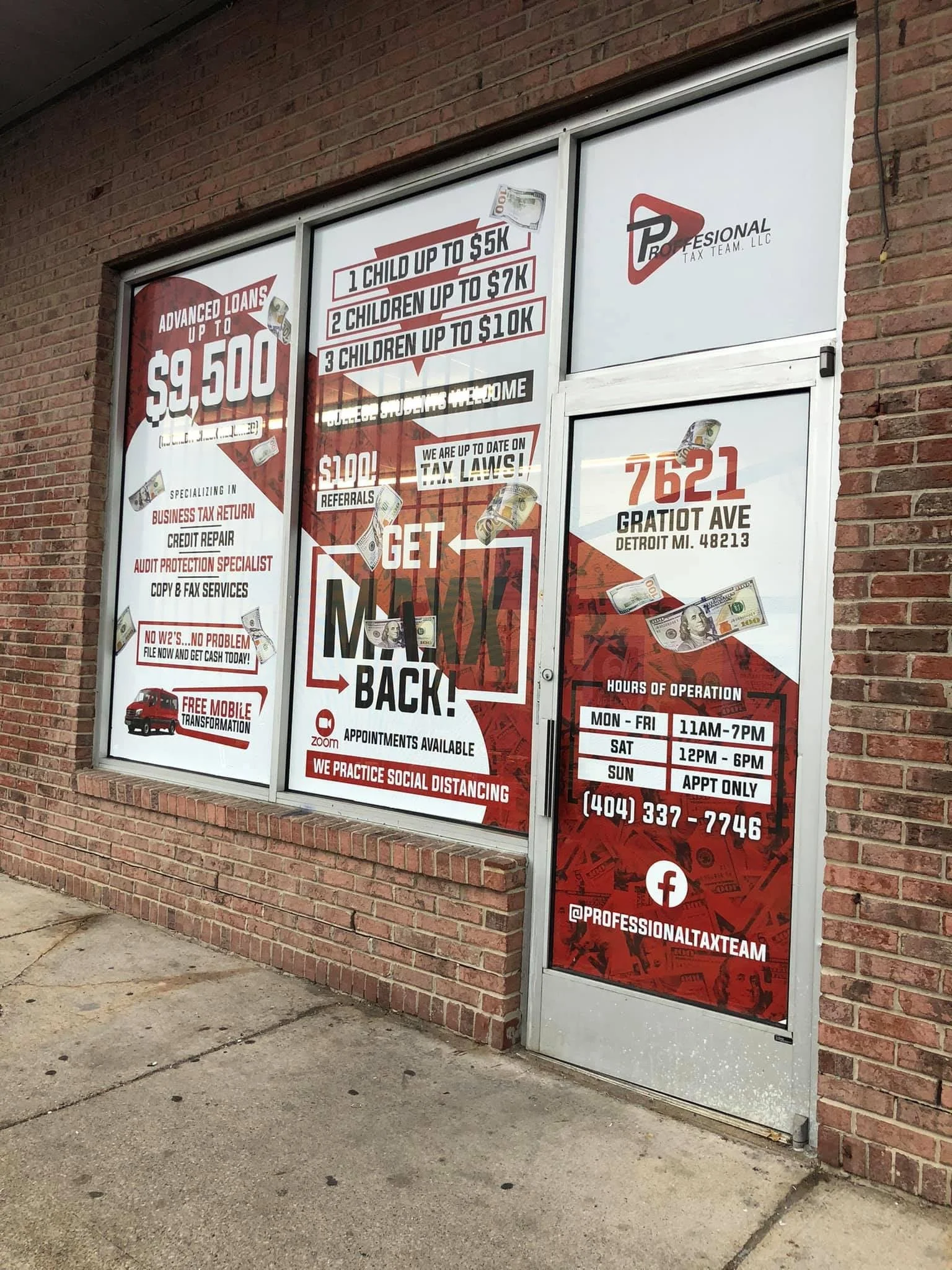 The storefront window advertising tax services and financial loans, including details about loan amounts, tax law updates, services offered, contact information, and business hours.