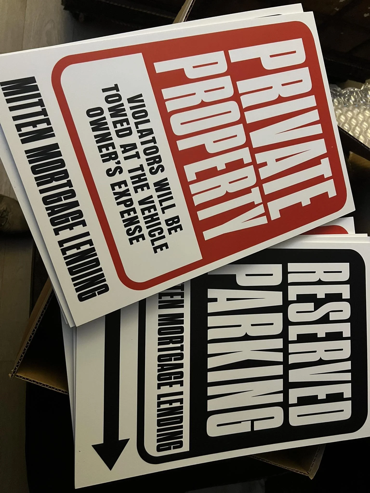 Two safety signs, one red and white, reading 'Prohibition - No Parking - Vehicles will be towed at the vehicle owner's expense', and one black and white, reading 'Rescue Operation - Traffic Moving Left or Right'.