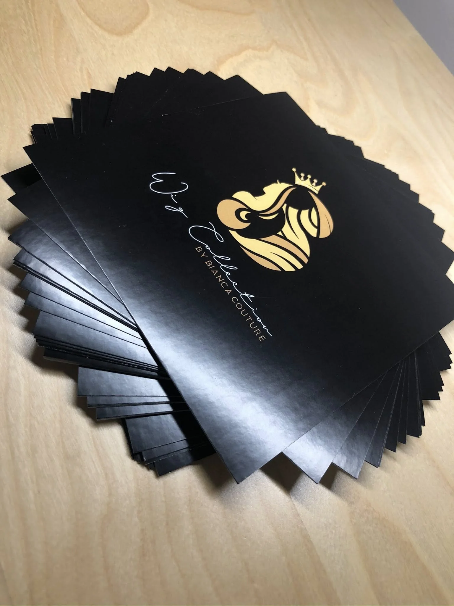 Stack of black cards with gold and white logo featuring a crowned mermaid, accompanied by the text 'By Bianca Couture'.