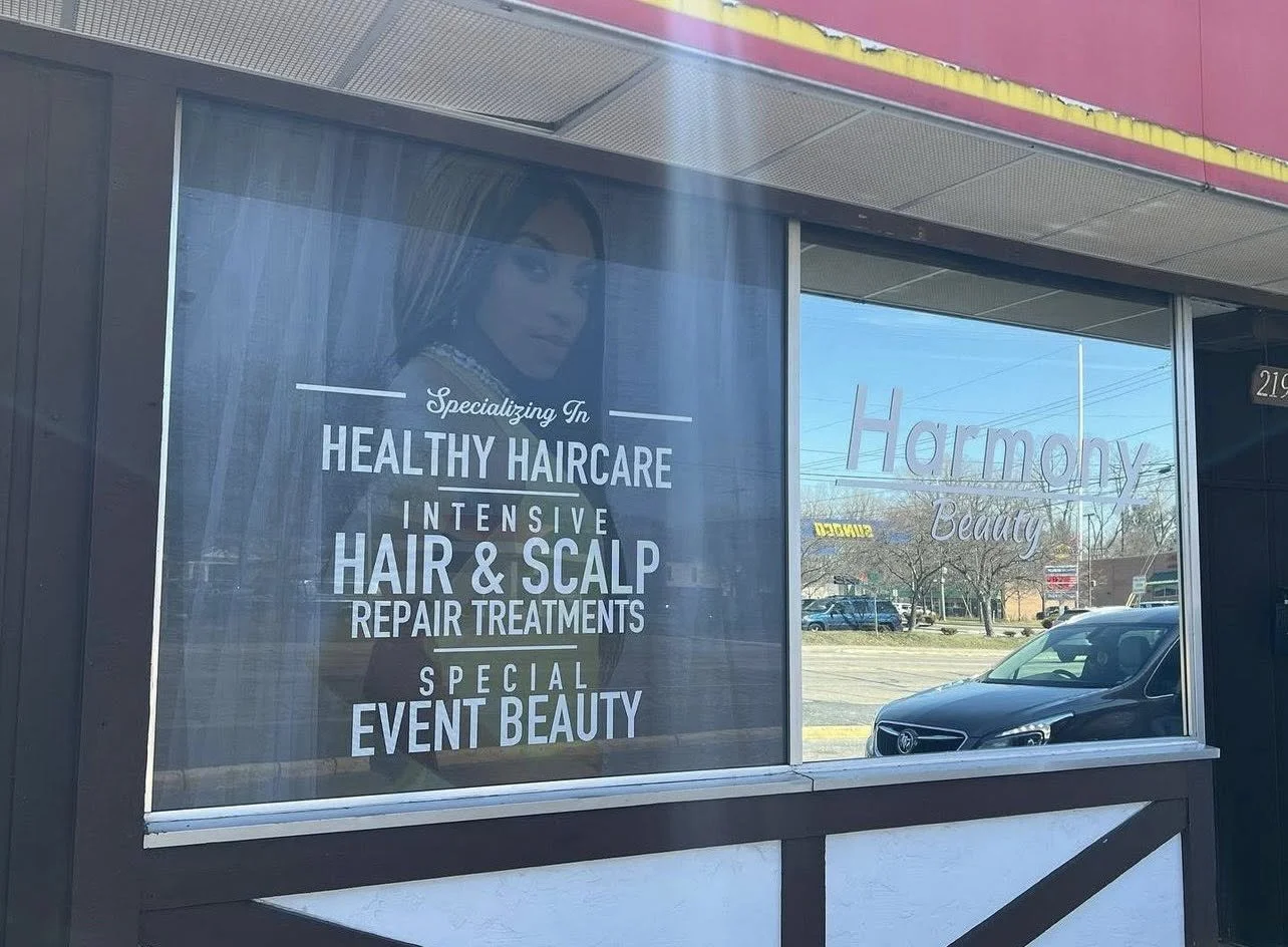 Window display advertising for Harmony Beauty, promoting healthy haircare, intensive hair and scalp repair treatments, and special event beauty.