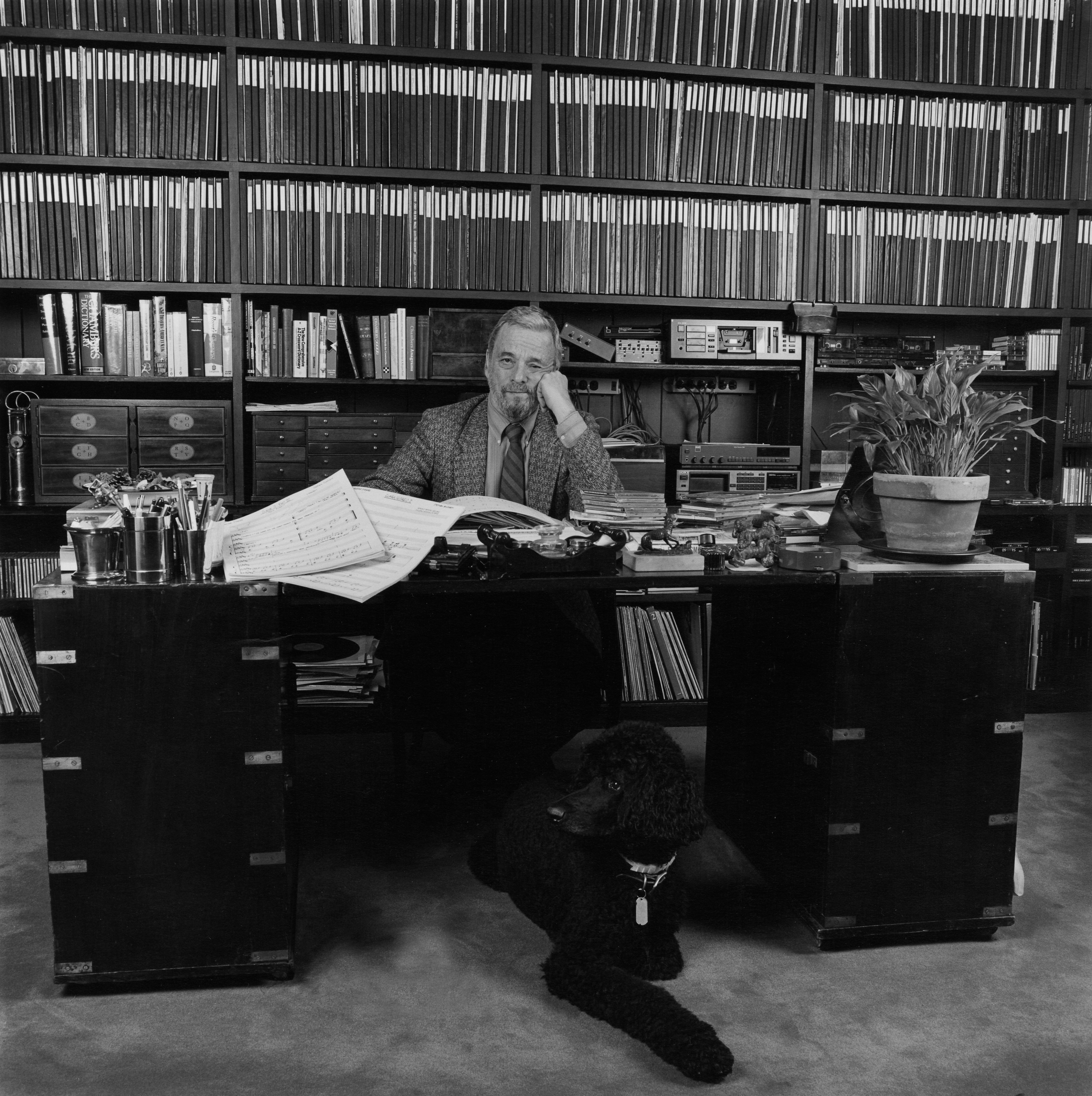 Stephen Sondheim in his New York City study in 1993 with his dog under the desk. Photo by Nancy Lee Katz