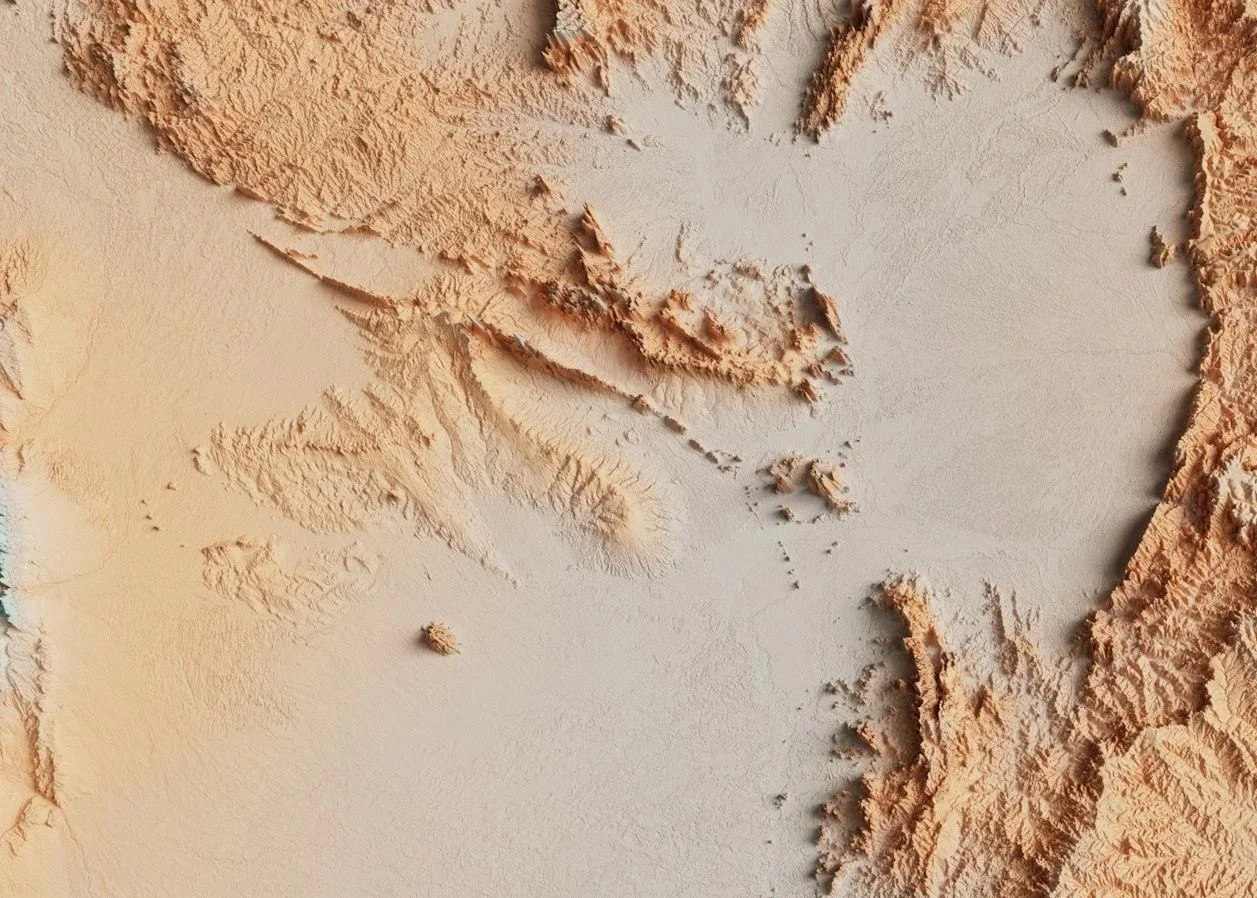 Satellite map showing terrain elevation, with mountain ranges and valleys in shades of beige and light brown.
