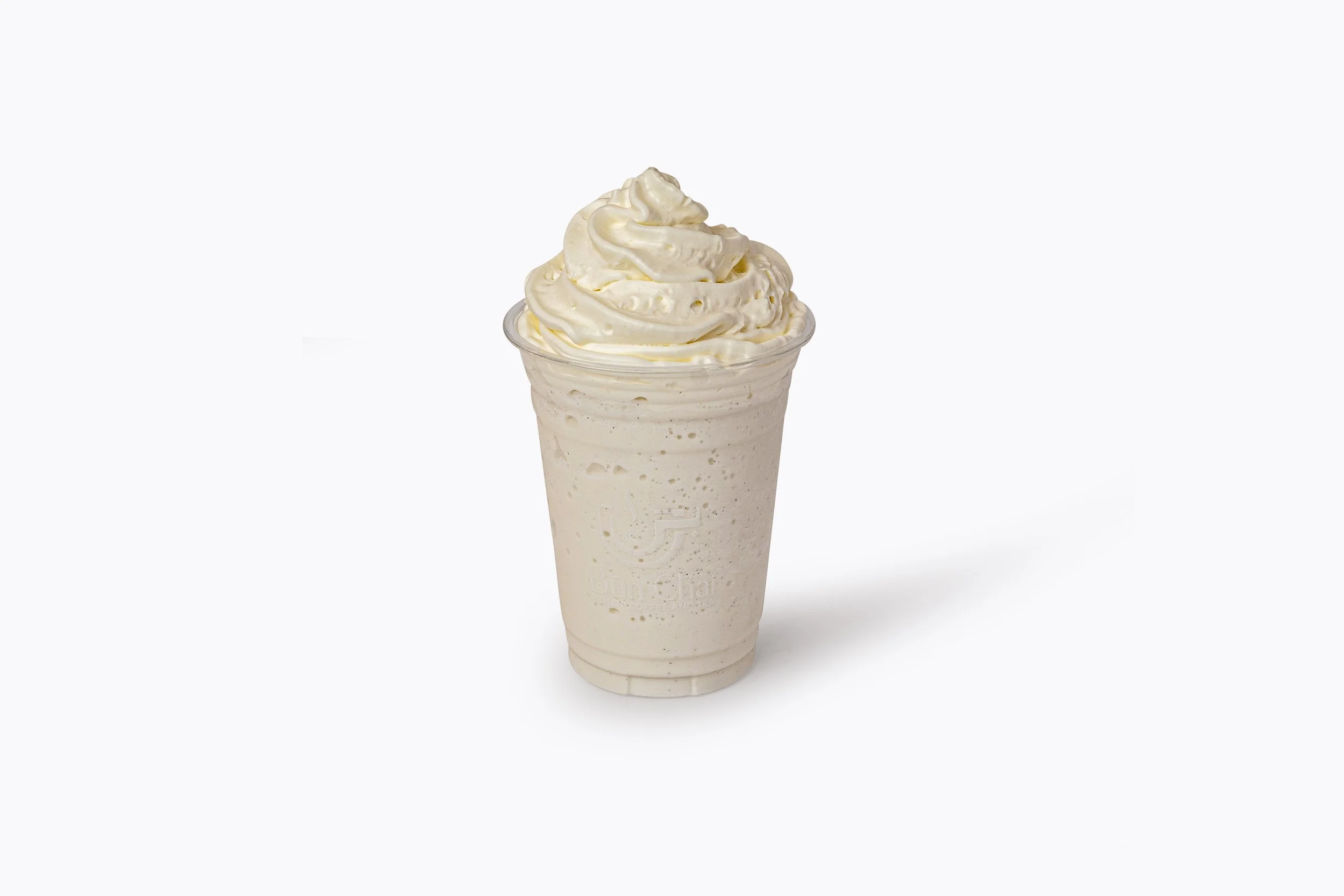 A cup of vanilla-flavored frappuccino with whipped cream on top, served in a clear plastic cup against a white background.