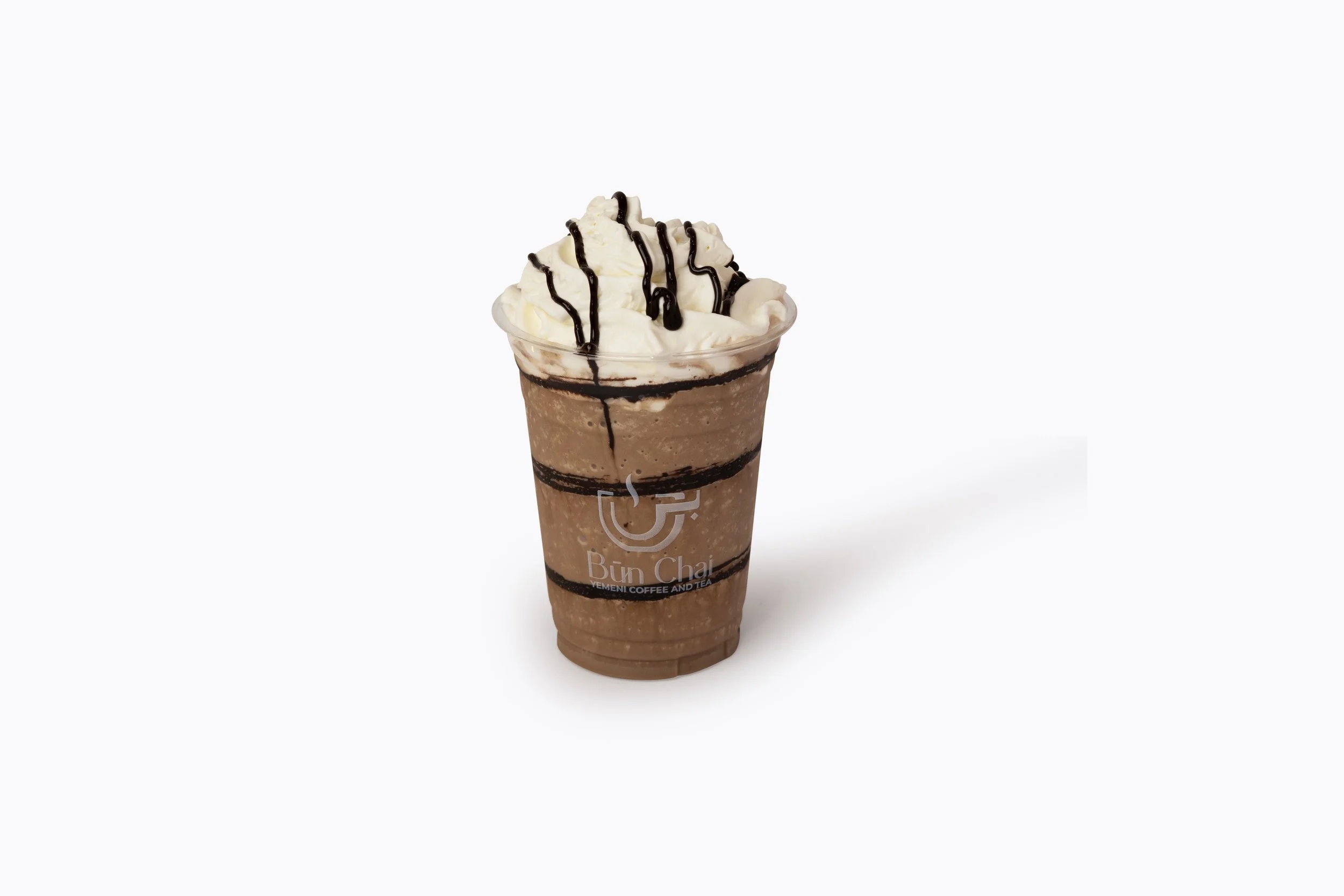 Chocolate frappuccino with whipped cream, chocolate drizzle, and chocolate syrup in a clear plastic cup labeled 'Bún Chải' on a white background.