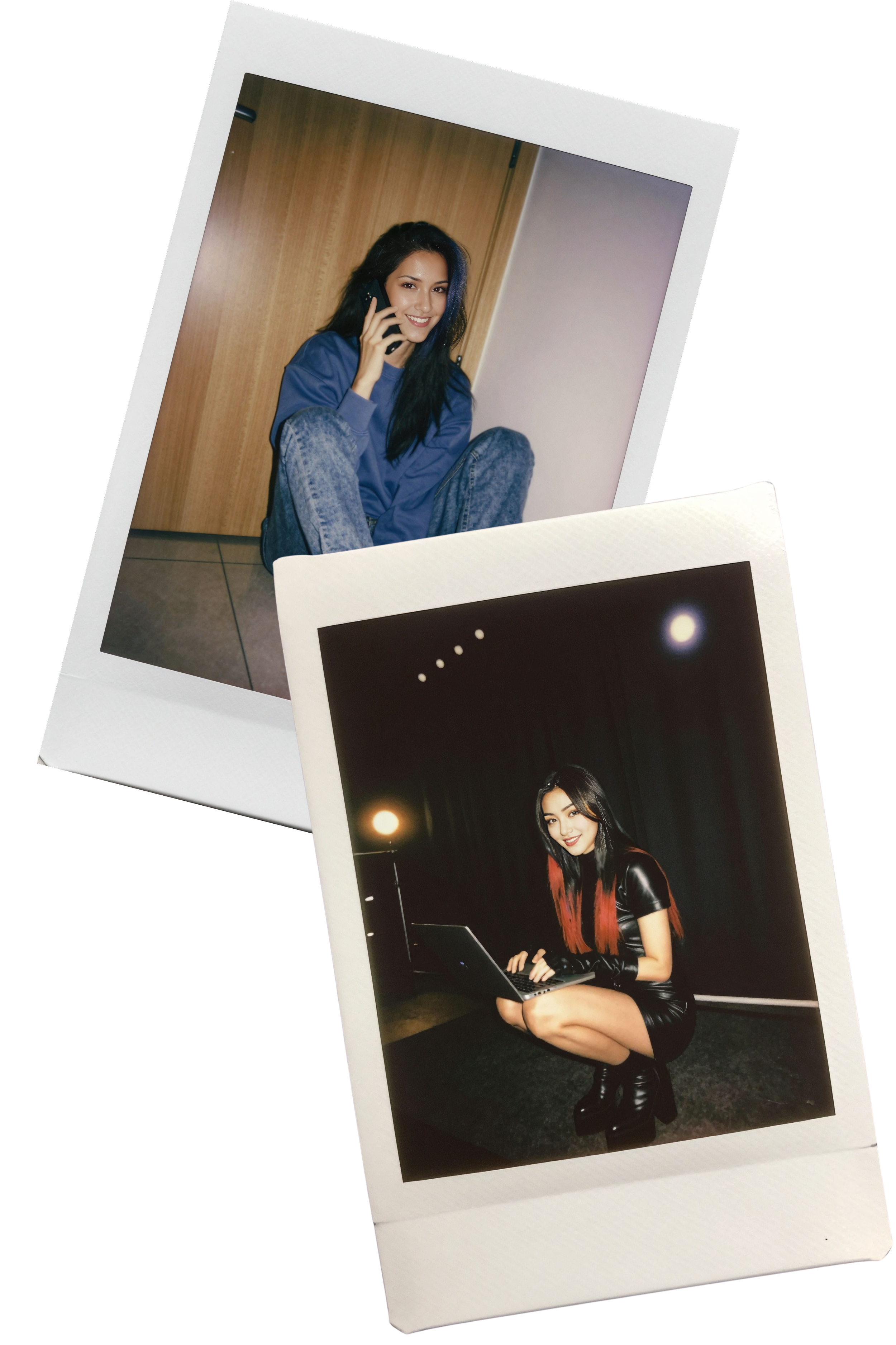 A woman with long black hair sitting on the floor, smiling, talking on a mobile phone, wearing a blue sweatshirt and acid-washed jeans, in front of a wooden door.