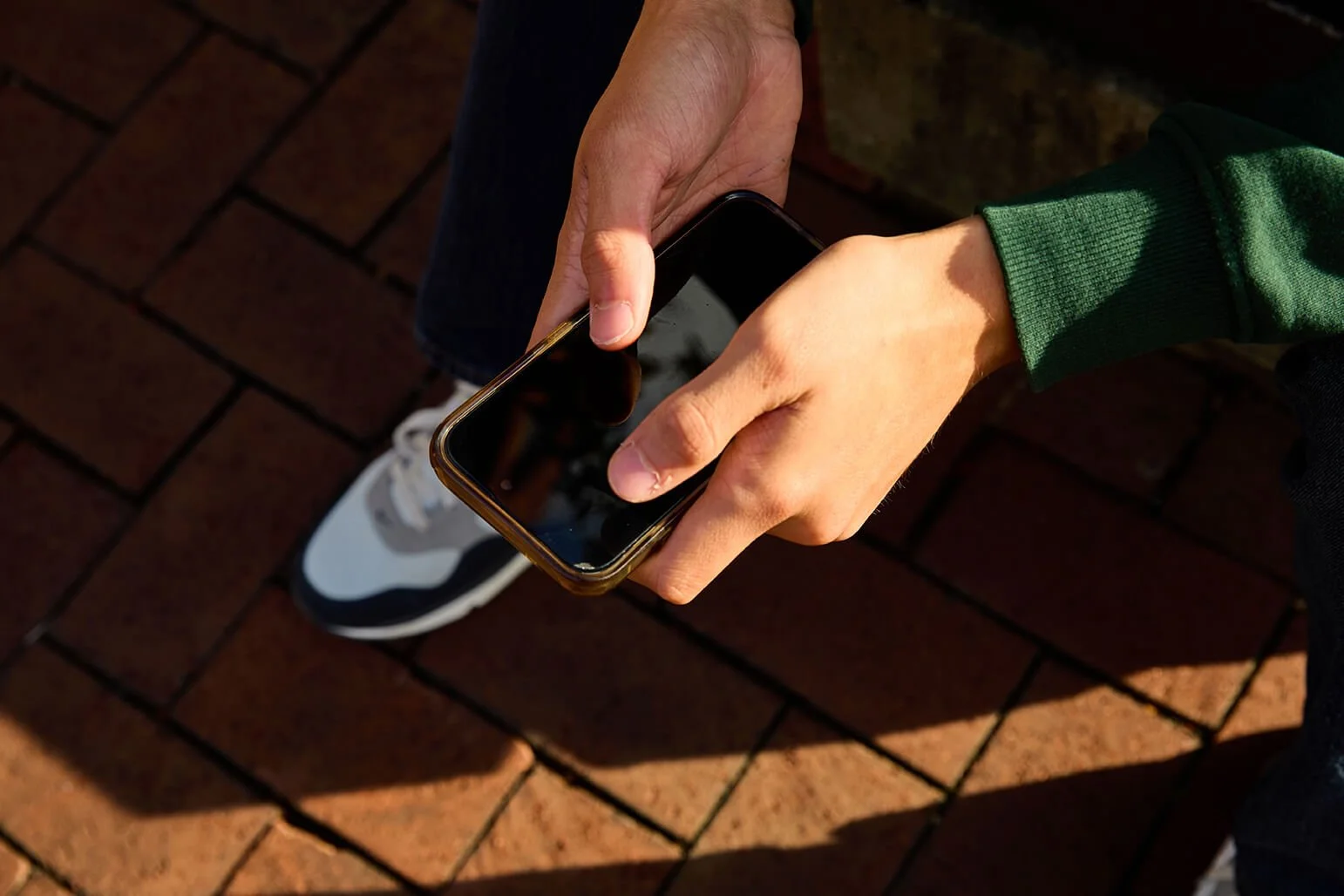 Close-up of hands holding a smartphone as if considering a phone call
