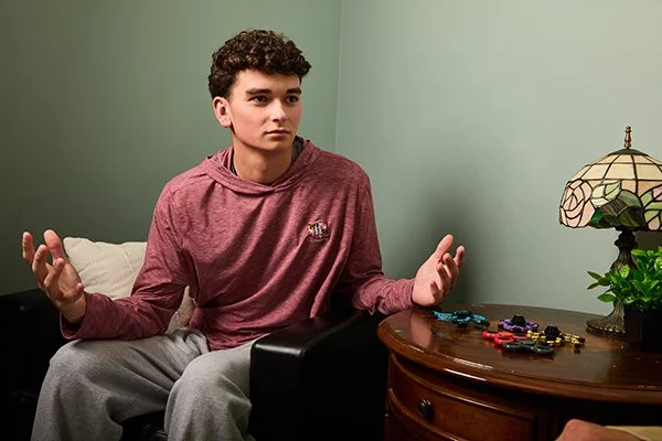 teen sits with adult in comfortable office