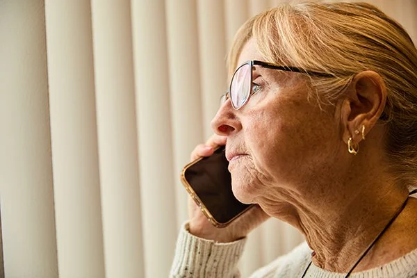 senior woman with blond hair making a phone call