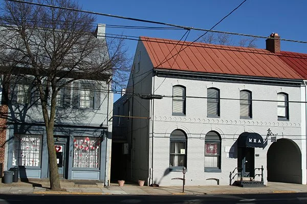 small gray building with red roof