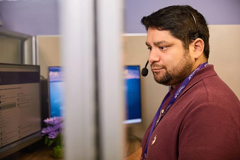 man with headset at mental health call center