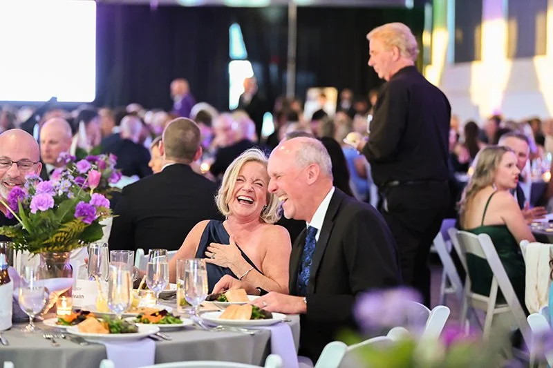A lively banquet scene with guests dressed in formal attire from the Catoctin Affair
