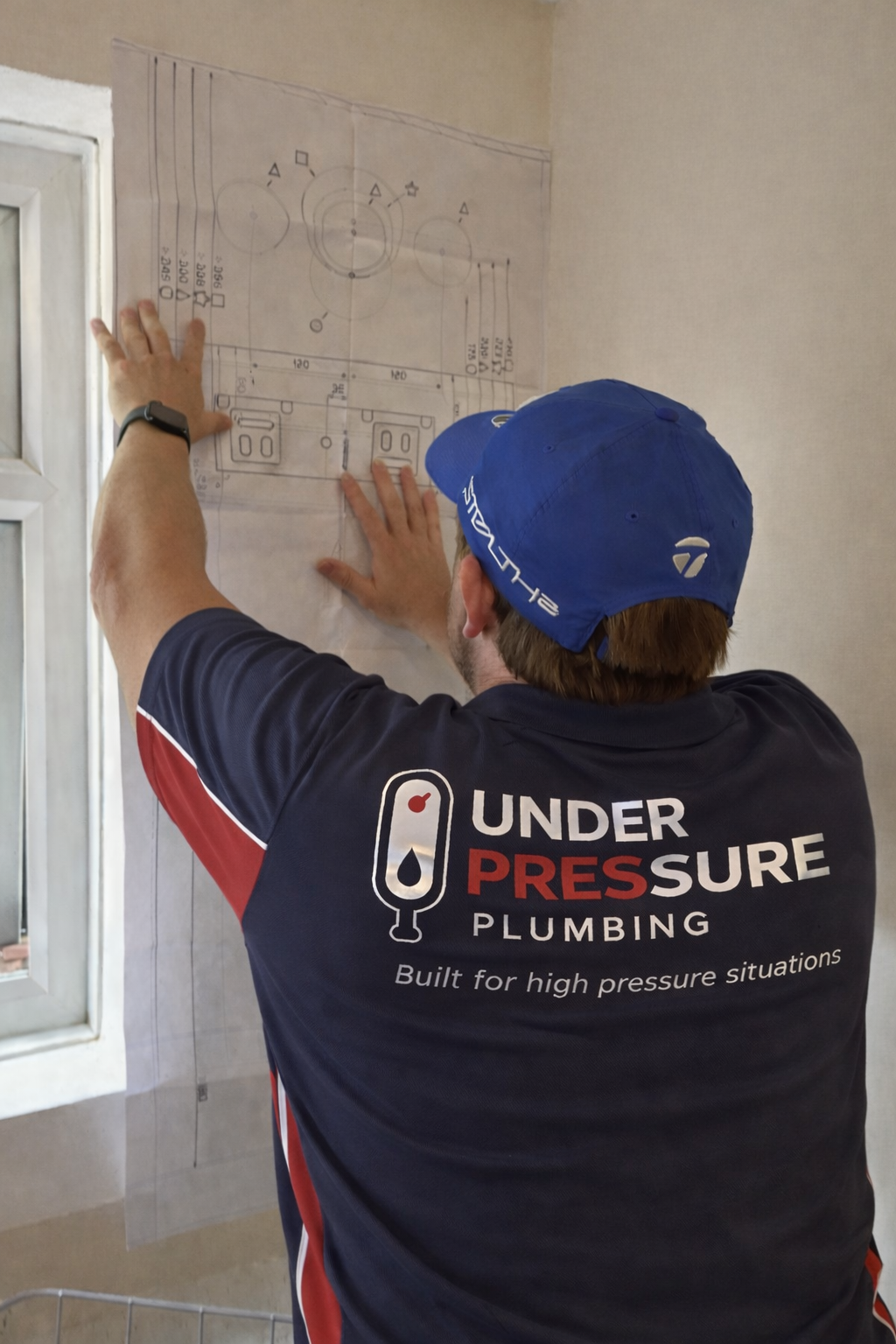 Plumber installing new bathroom fixtures and plumbing system in London