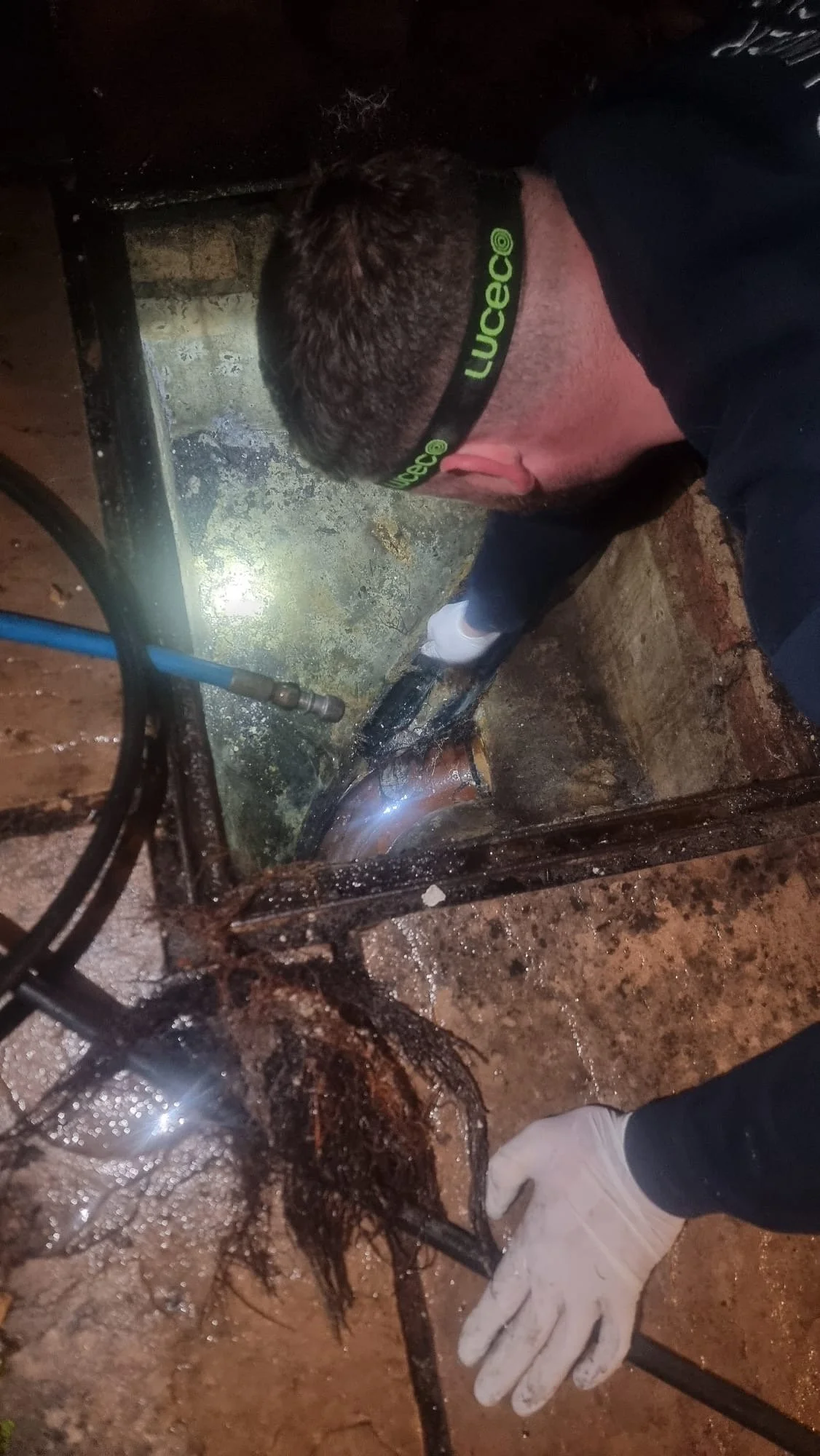 High-pressure drain jetting being used to remove a blockage from a drainage system.