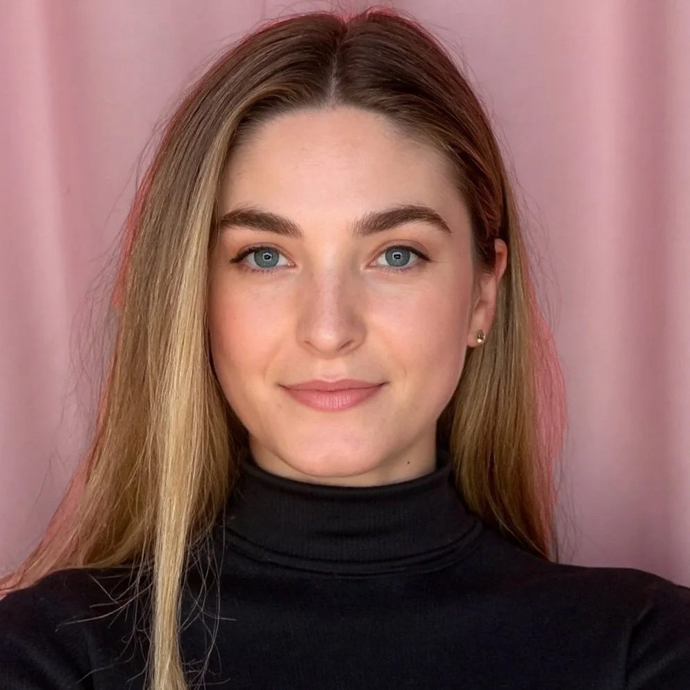 Portrait of a young woman with blue eyes, light brown hair, wearing a black turtleneck, standing in front of a pink background. Madison Long Madison Gabriel Madison (Gabriel) Long therapist counselor therapy Flourish Counseling and Consulting