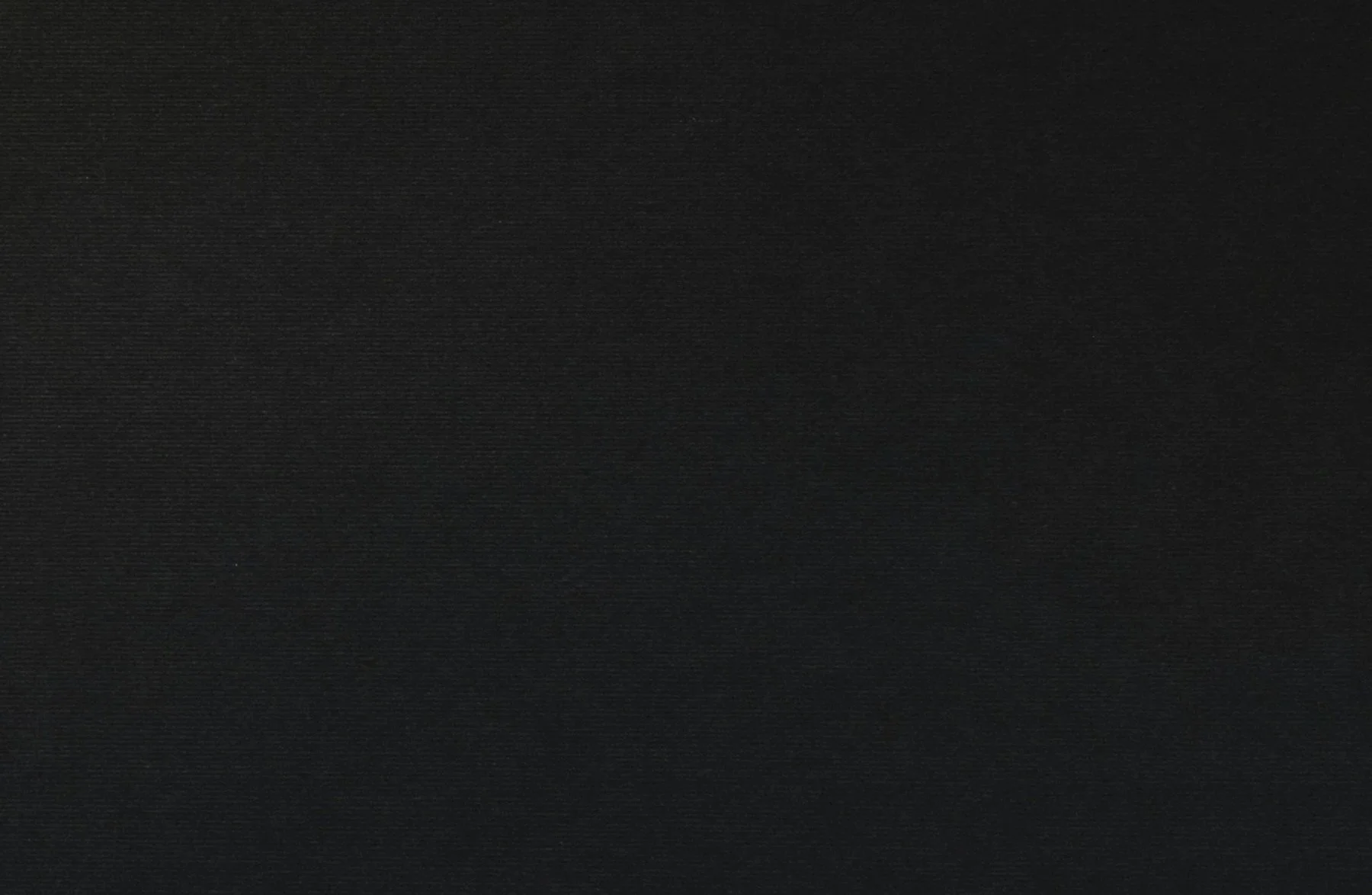 A plain, black textured surface.