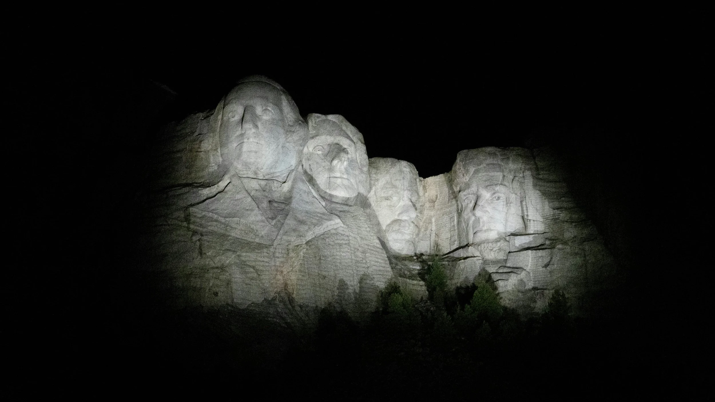 Mount Rushmore National Memorial illuminated four U.S. presidents' faces at night in the Black Hills of South Dakota