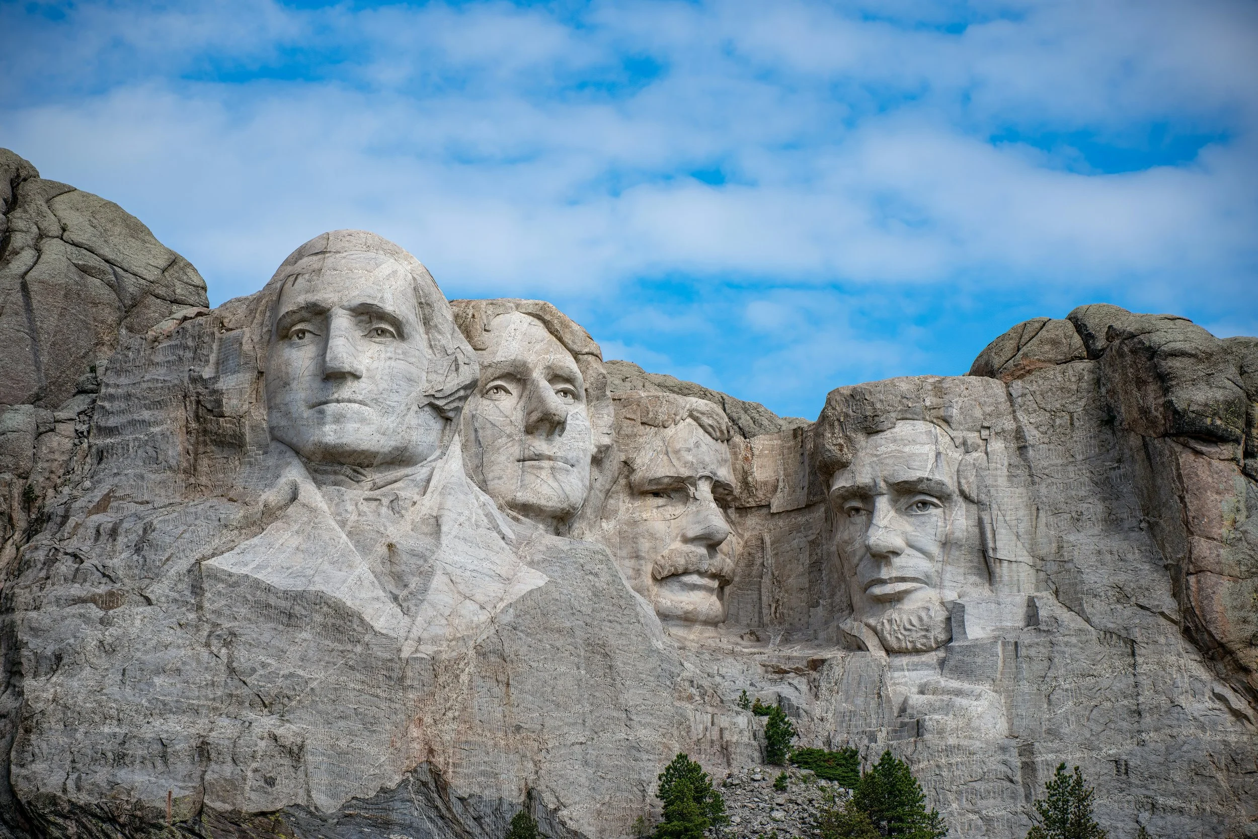 Mount Rushmore with the carved faces of George Washington, Thomas Jefferson, Theodore Roosevelt, and Abraham Lincoln in the Black Hills of South Dakota