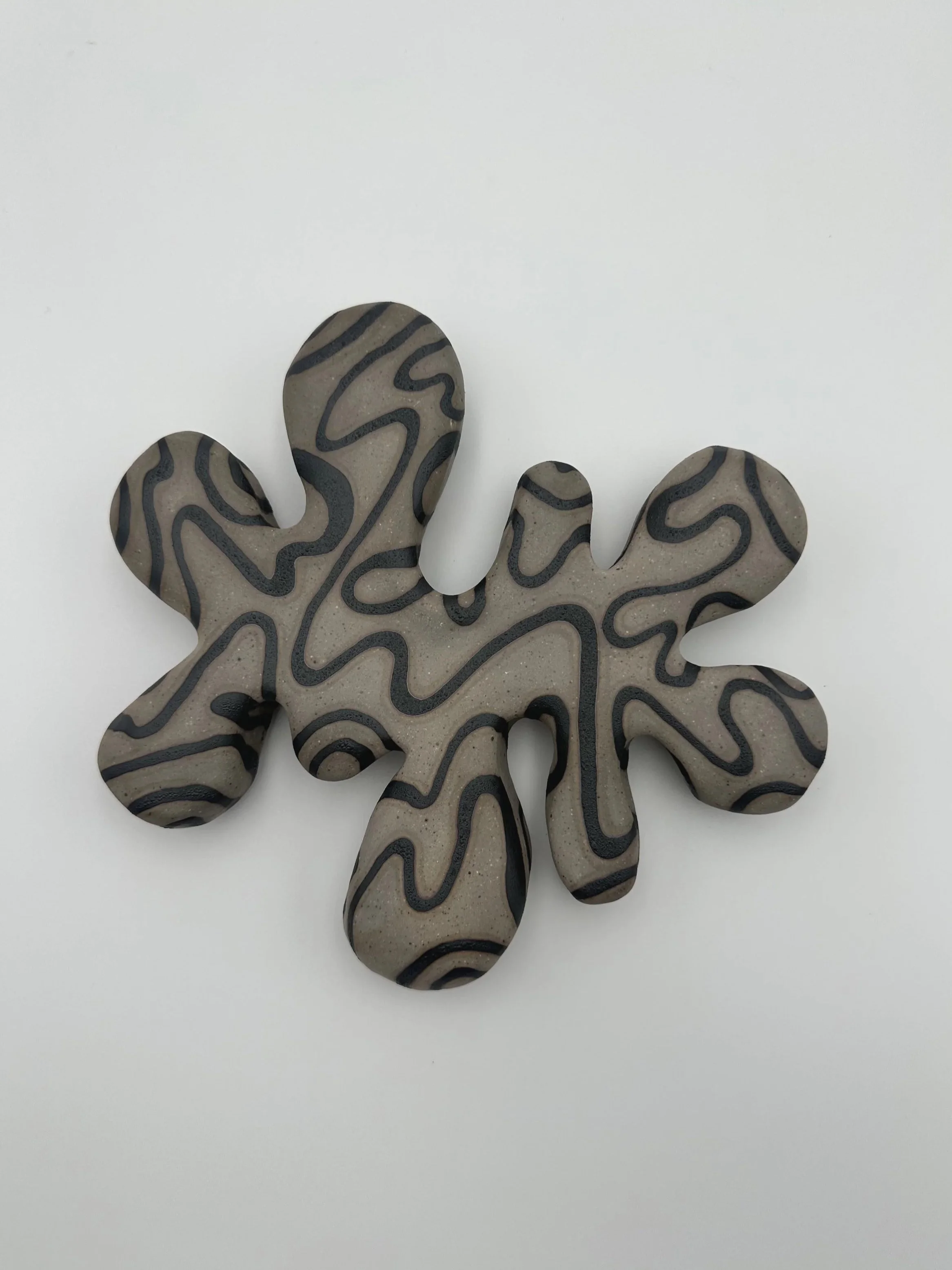 PLASMA WALL SCULPTURE BLACK UNDER GLAZE ON RAW WHITE STONEWARE