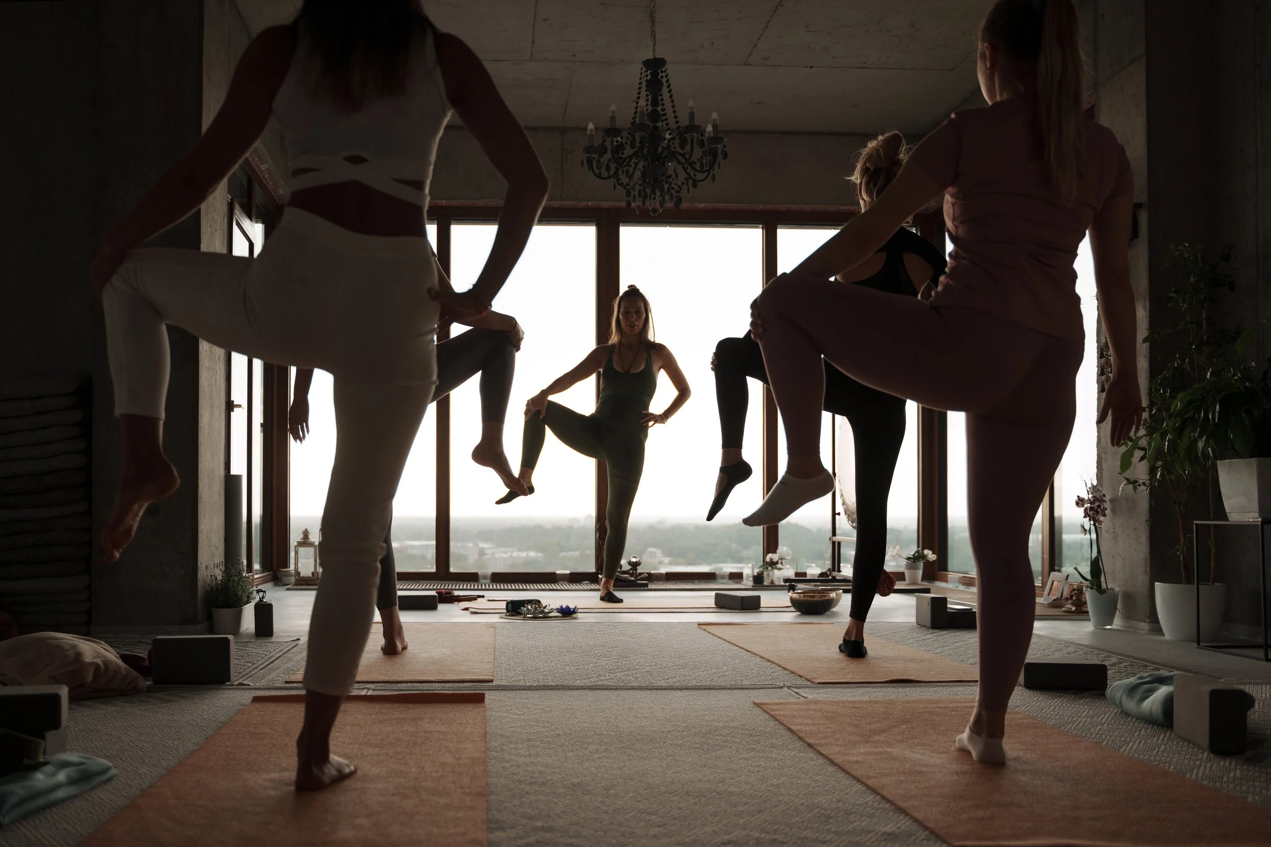 The Atrium wellness club members practicing together in bright Bainbridge Island studio