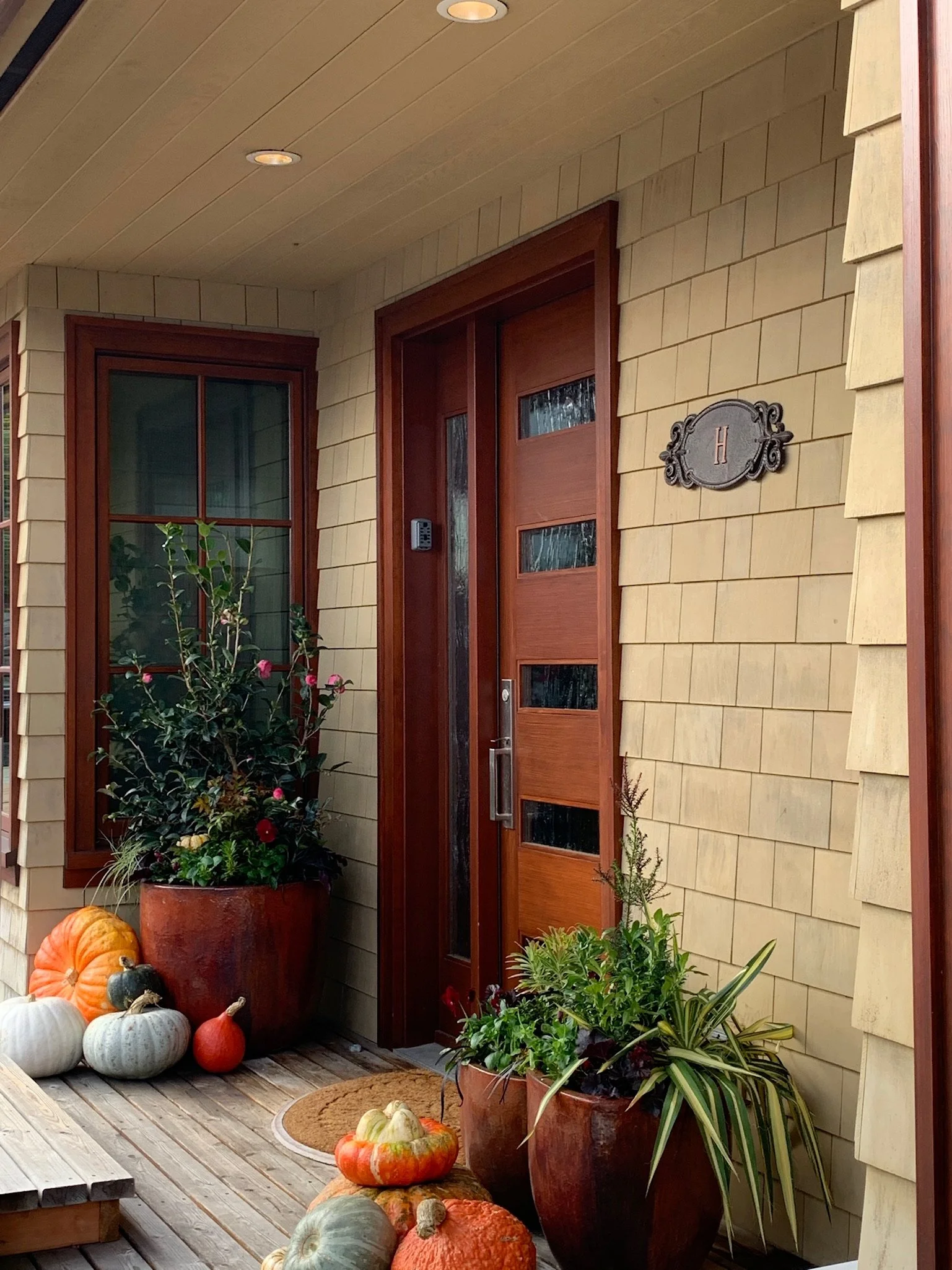 Fall container with pumpkins at base at entry of houseboat