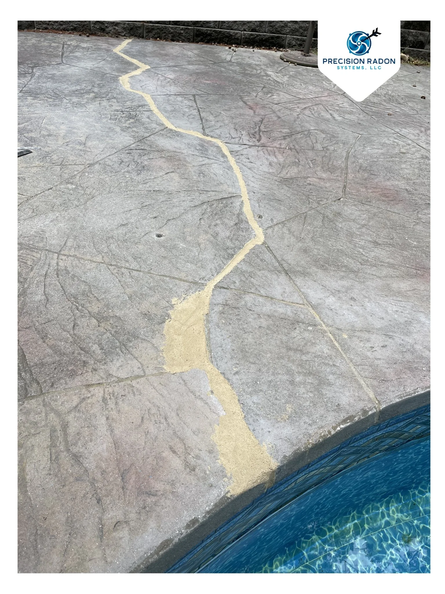 Concrete pool deck with visible cracks sealed with caulking to keep the integrity of the pool deck.
