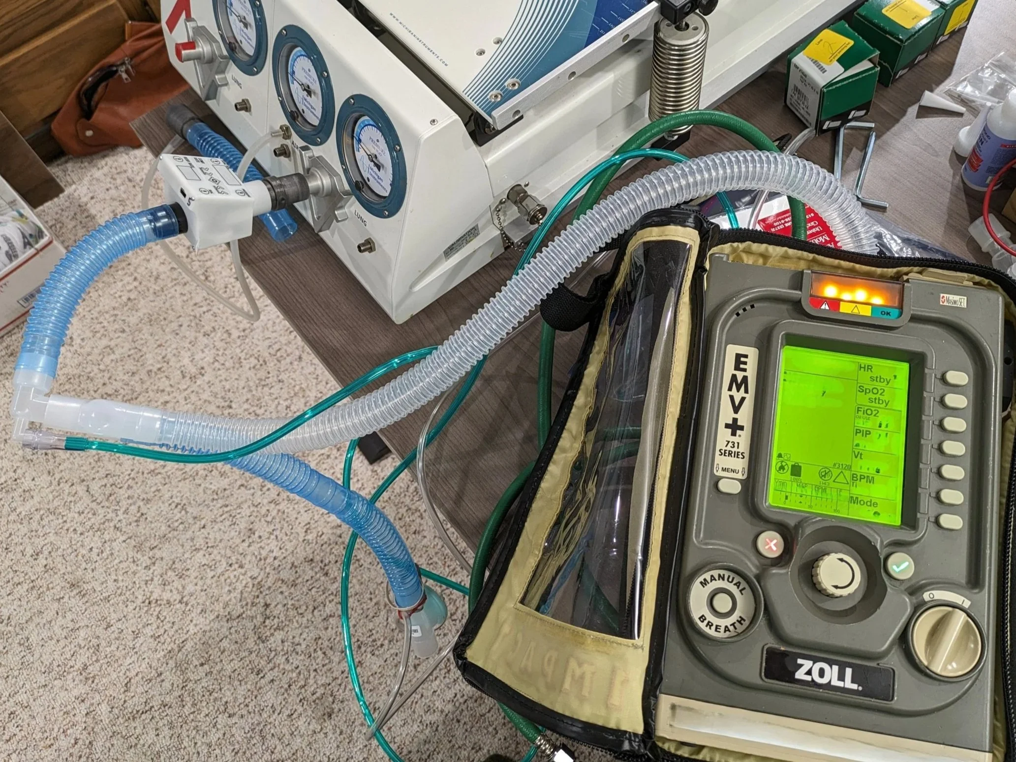 Testing version 3 hardware/software against lab reference instruments and portable emergency ventilator (displays obscured for confidentiality.)