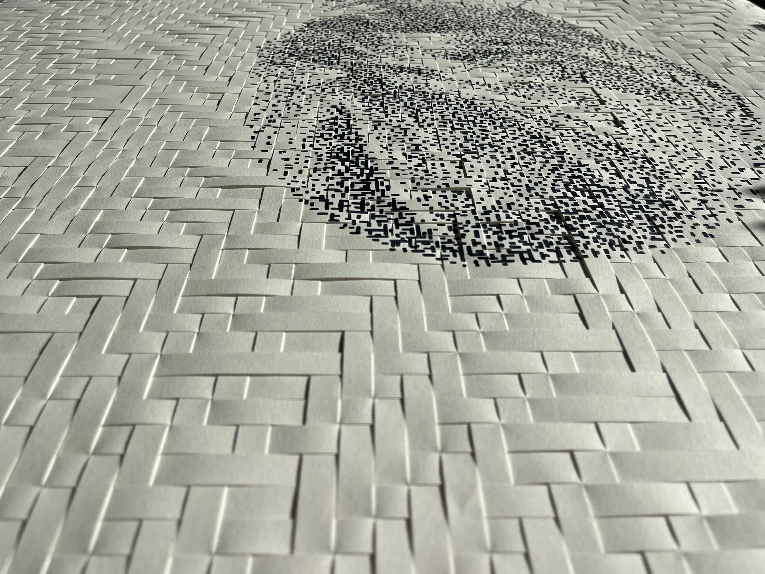 A wall with a large QR code embedded in a white brick pattern.