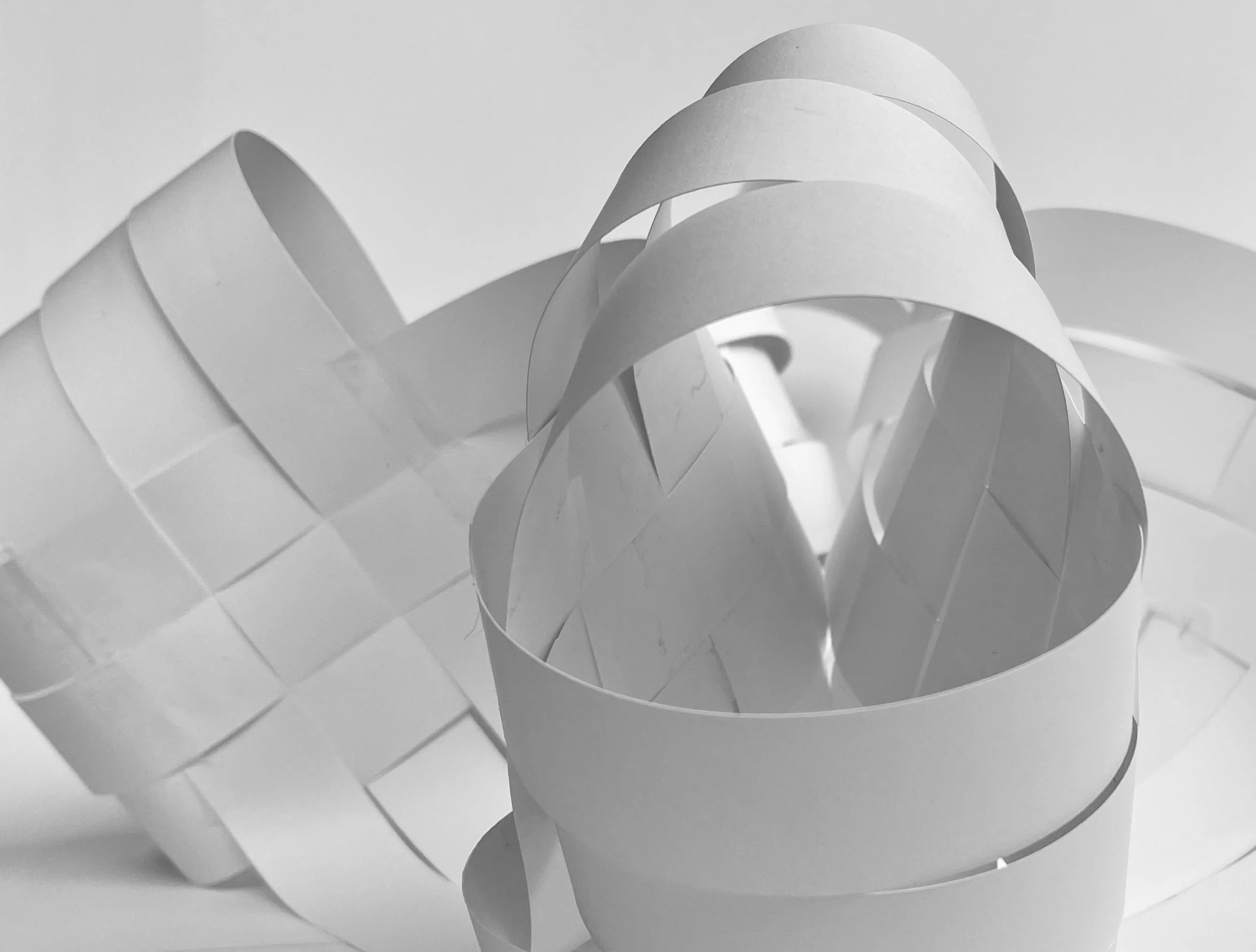 Close-up of a heart-shaped paper craft with ribbon details in black and white.