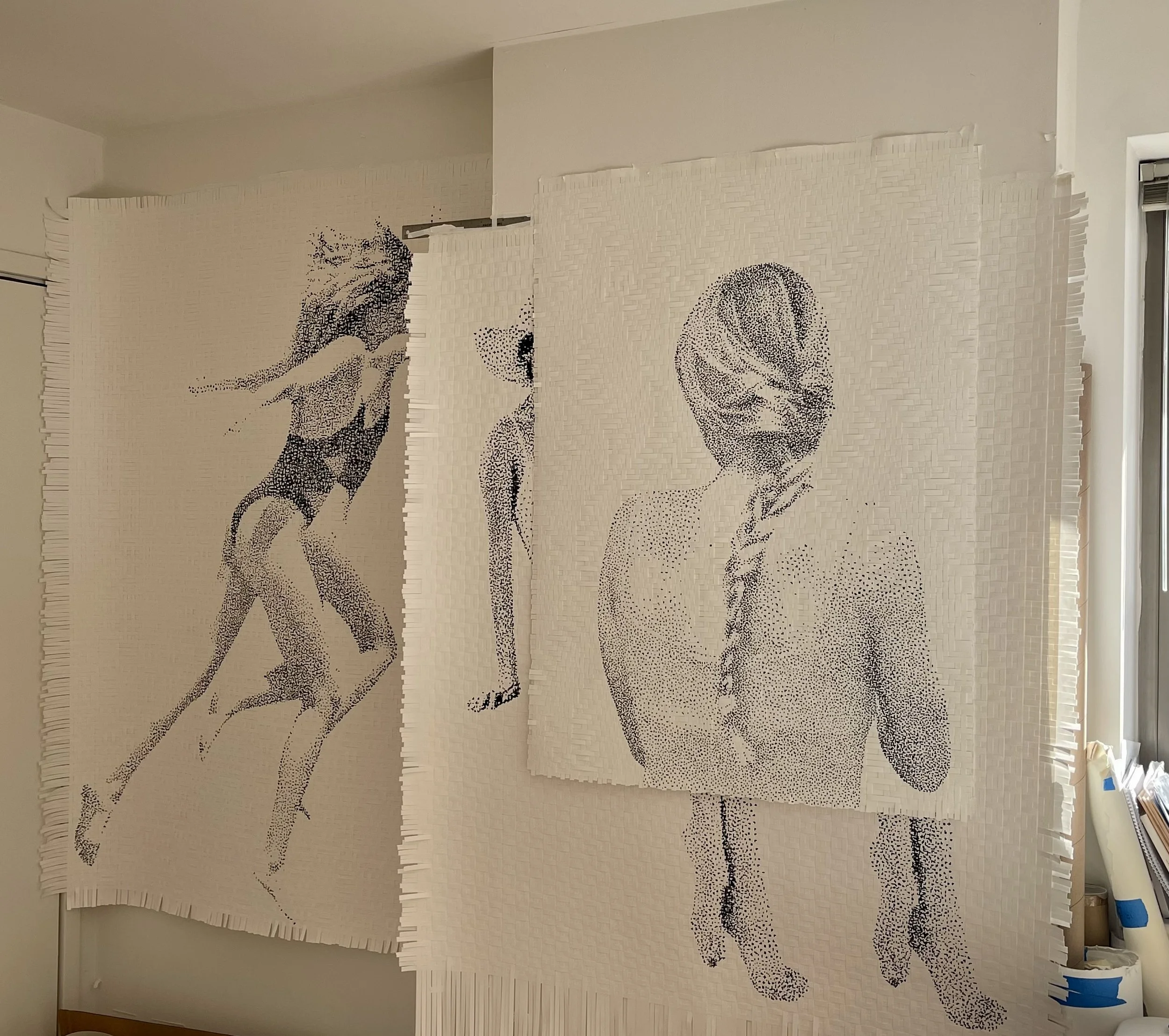Large paper mural depicting a woman in a bikini running, another woman walking, and a woman with her hair in a braid, all created with small black dots on white background.
