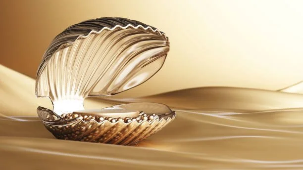 Shiny metallic seashell with ridges, slightly open, resting on a smooth, reflective surface with soft lighting.