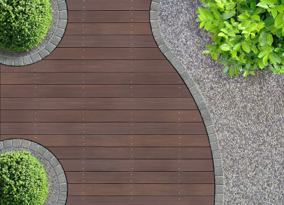 Aerial view of a curved wooden deck with stone edging, surrounded by green shrubs and gravel landscaping for a modern look