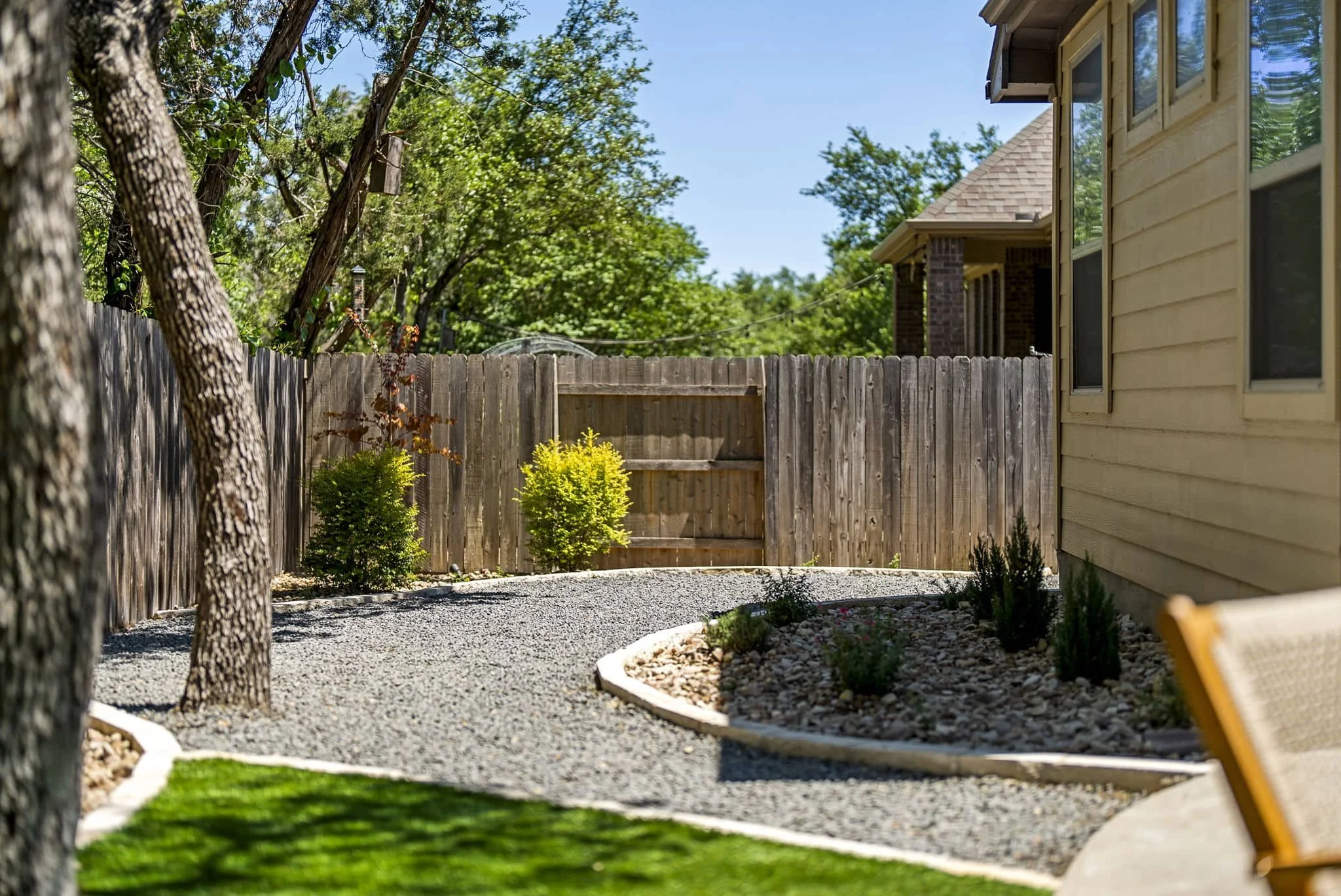 Resort-inspired backyard design with custom artificial turf and relaxing covered lounge — Southern Love