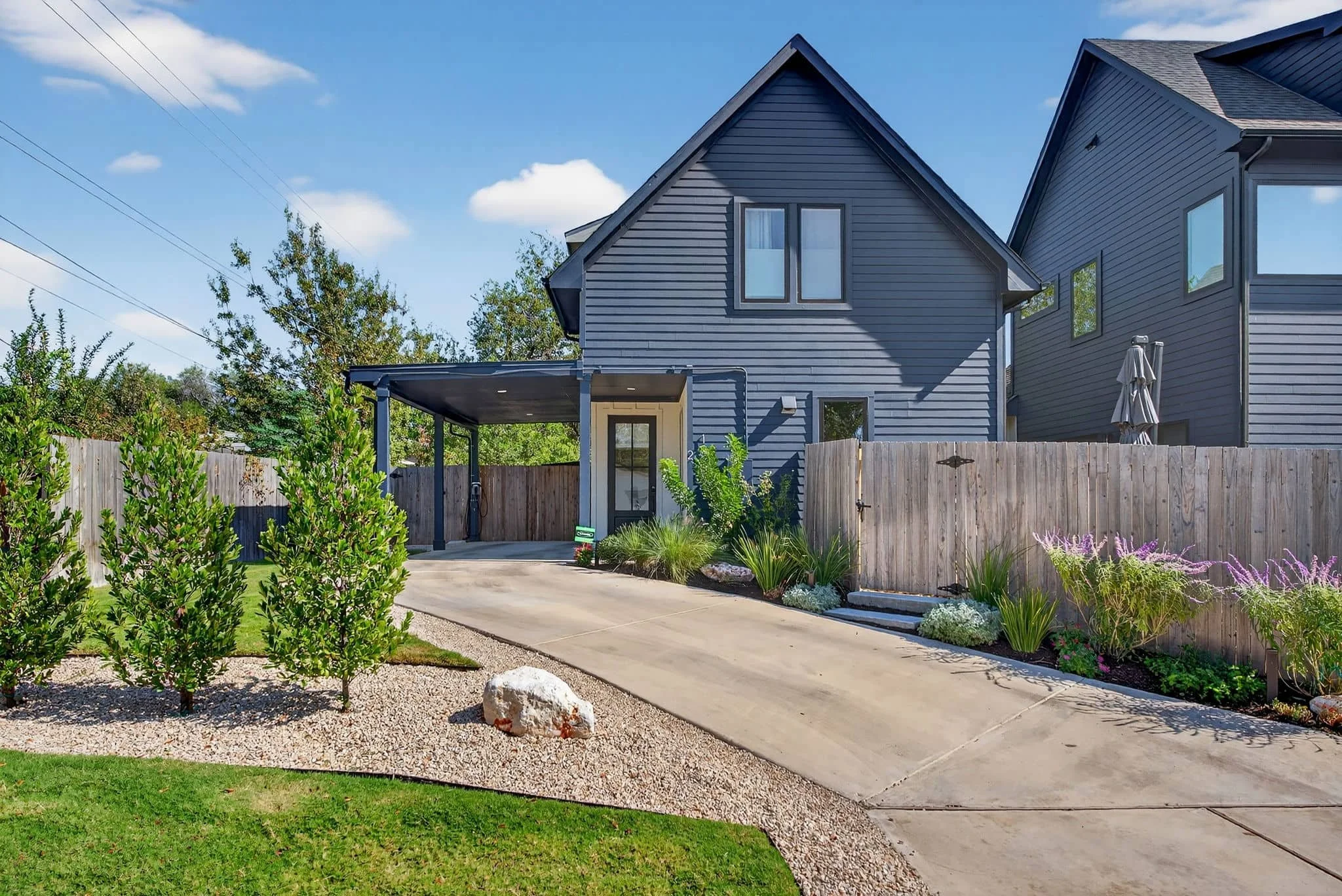 Small backyard landscape design with gravel areas and lush low-maintenance planting — Southern Love