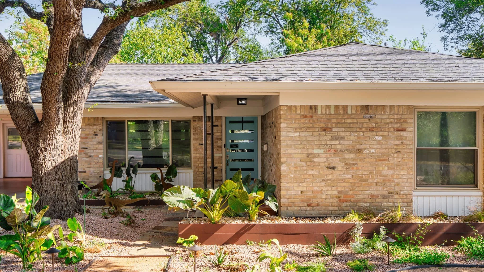 Natural-style front yard landscape with layered greenery and low-maintenance materials — Southern Love